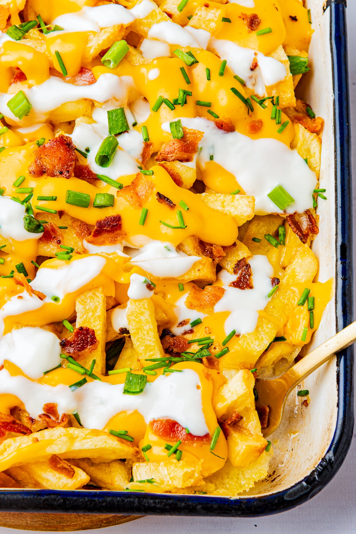 overhead image of Loaded French Fries with a fork in the baking dish