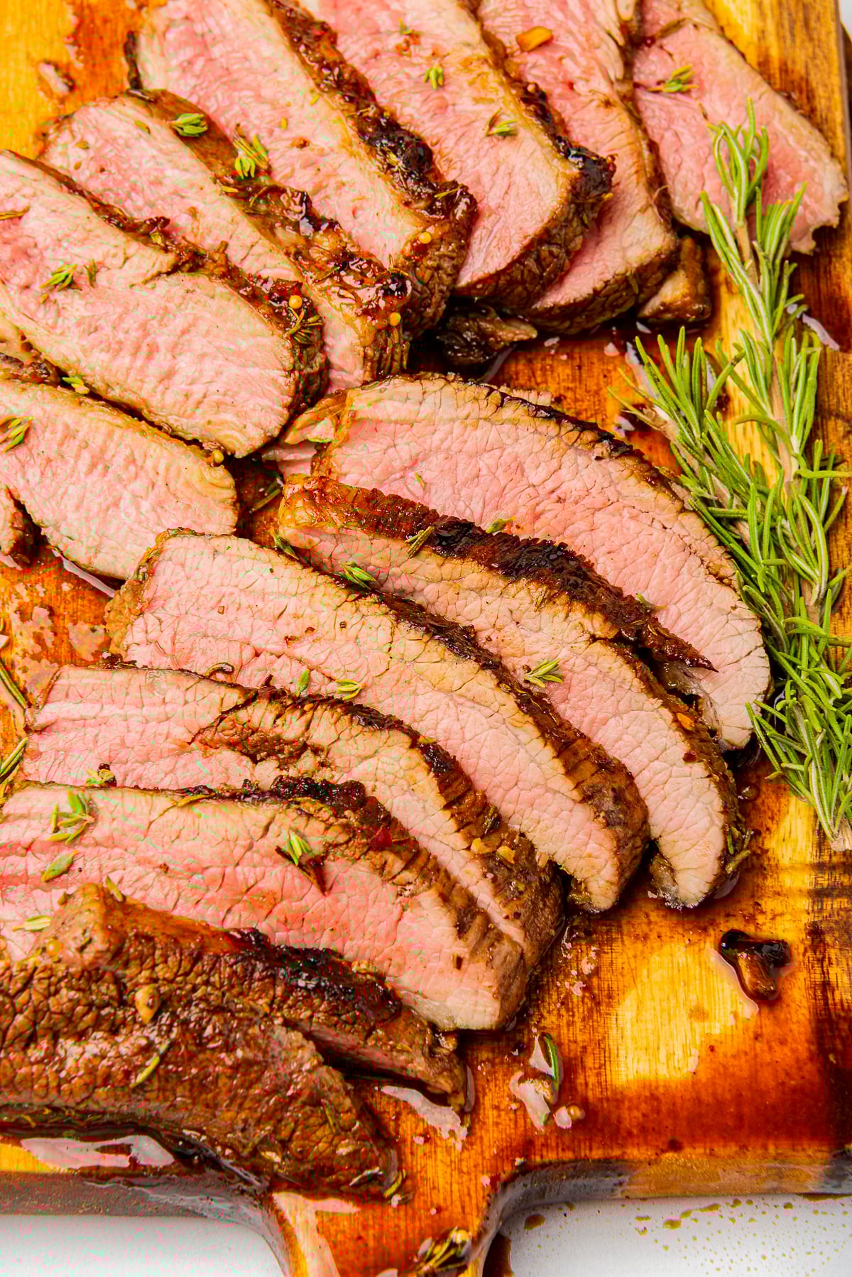 overhead image of sliced steak using London Broil Marinade o a wooden board