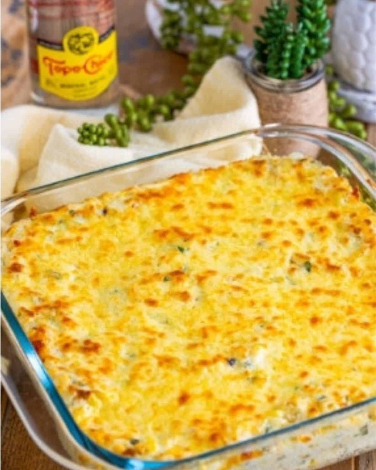 baked mexican street corn dip in a baking dish, golden brown.