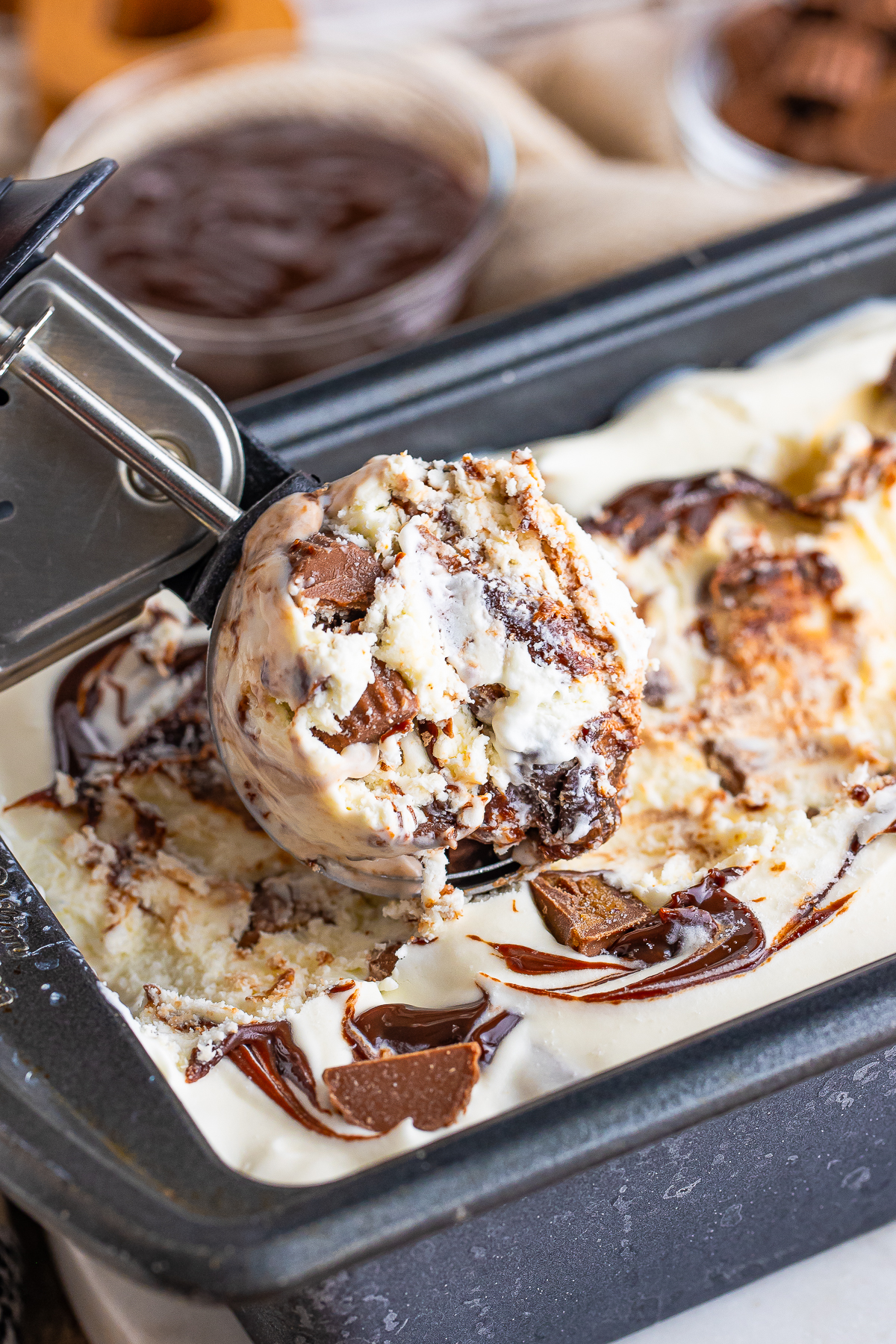an ice cream scoop with Moose Tracks Ice Cream in it in the pan