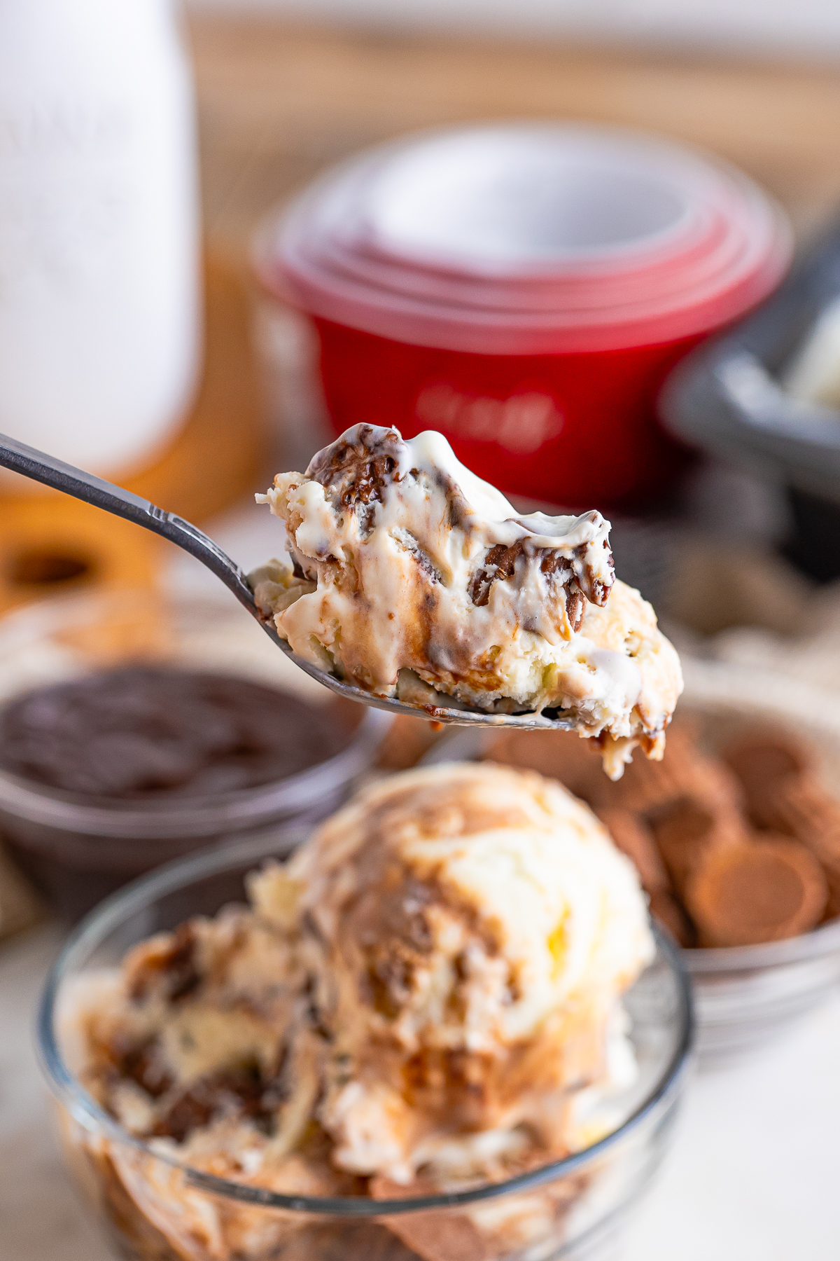a spoon holding up a bite of Moose Tracks Ice Cream in air
