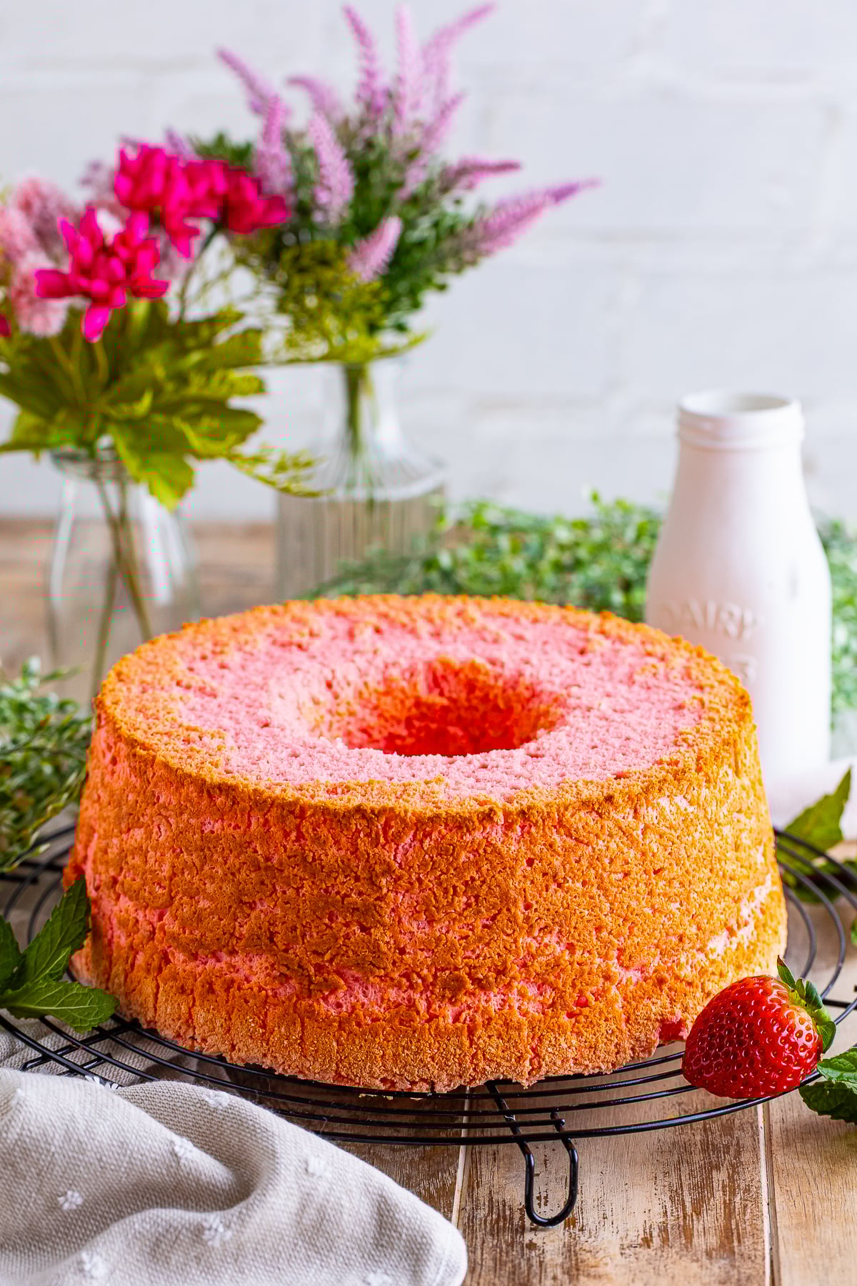 Strawberry Angel Food Cake on a wire rack