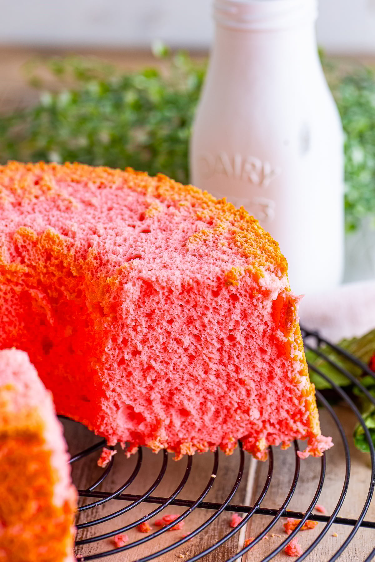 Strawberry Angel Food Cake on a wire rack with slices taken out