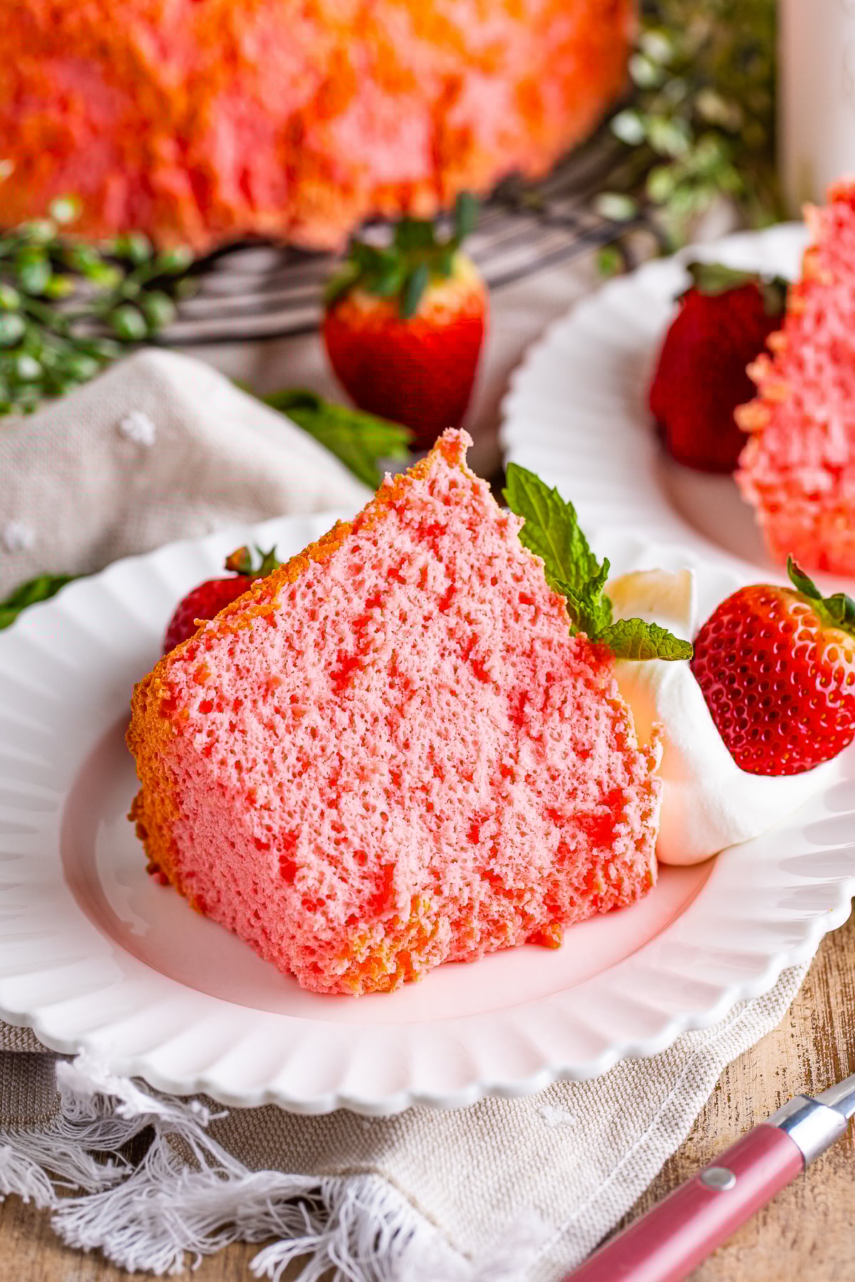 a slice of Strawberry Angel Food Cake on a white plate