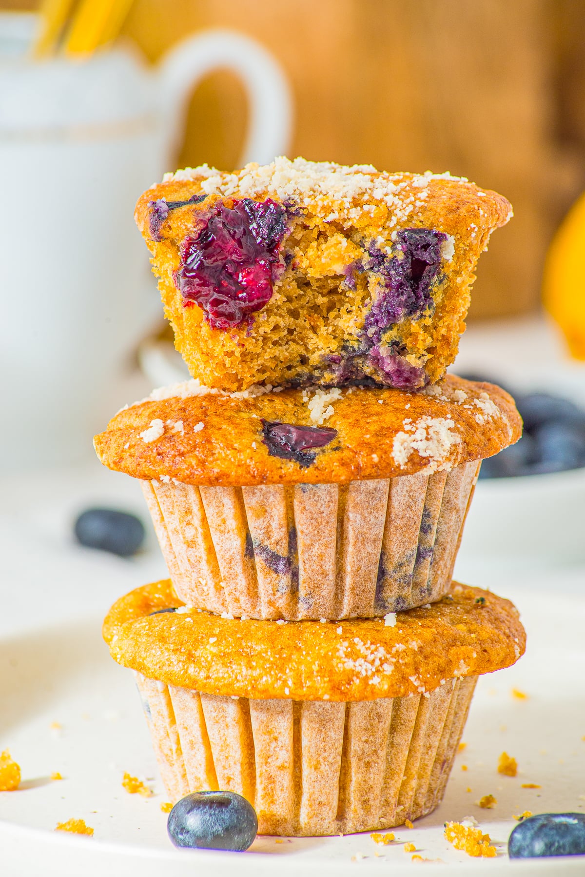 three cottage cheese muffins stacked on top of each other, the one on top has a bite taken out