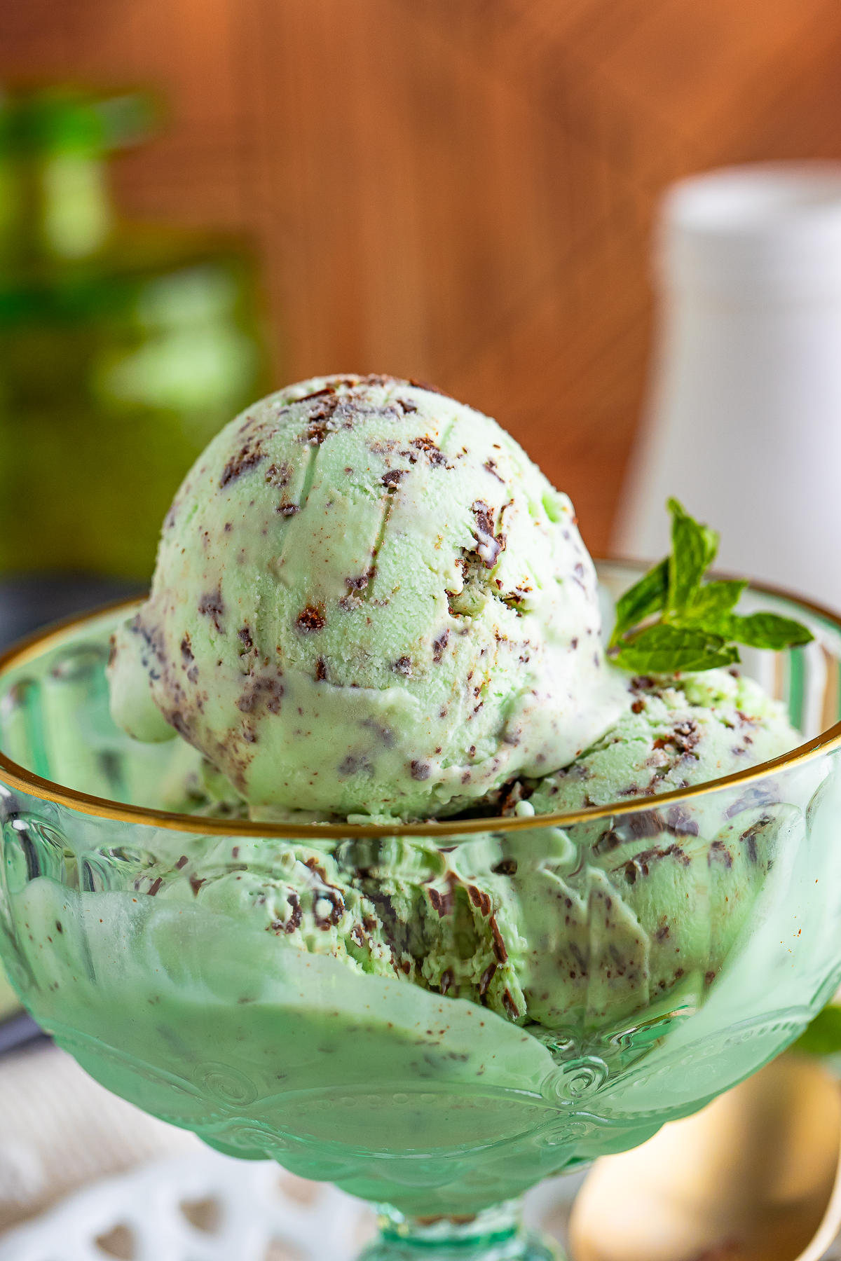 up close image of mint chocolate chip ice cream in glass bowl