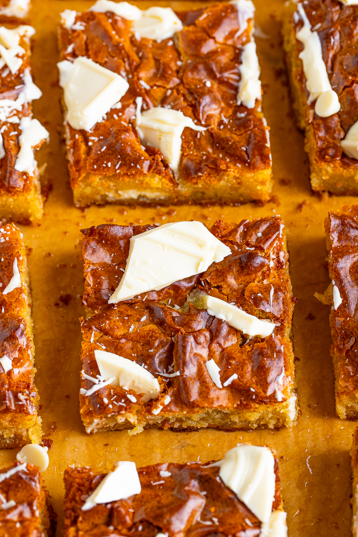 White Chocolate Brownies cut into bars on parchment paper