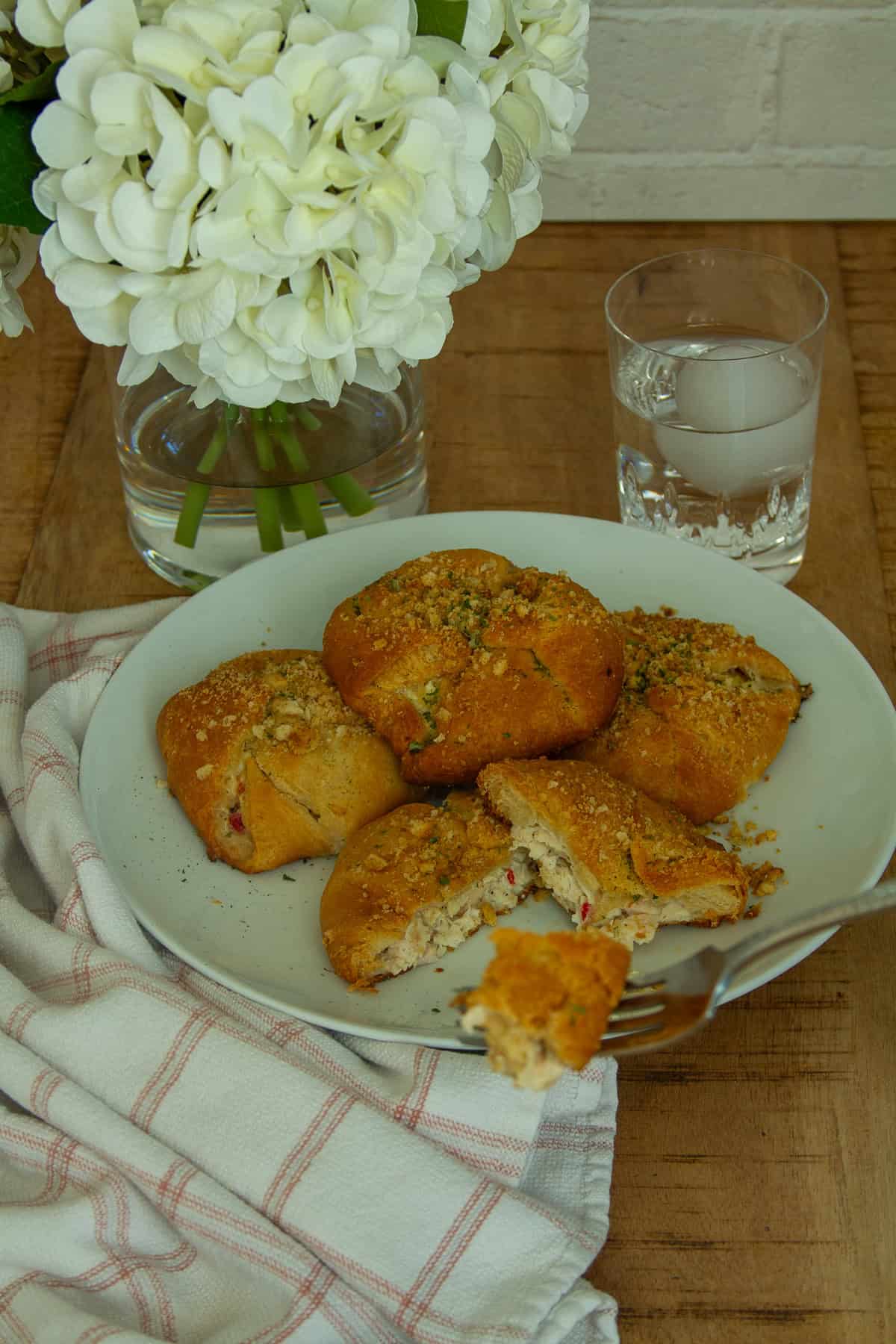 A picture of the chicken crescent rolls with a piece of the chicken crescent roll being taken out