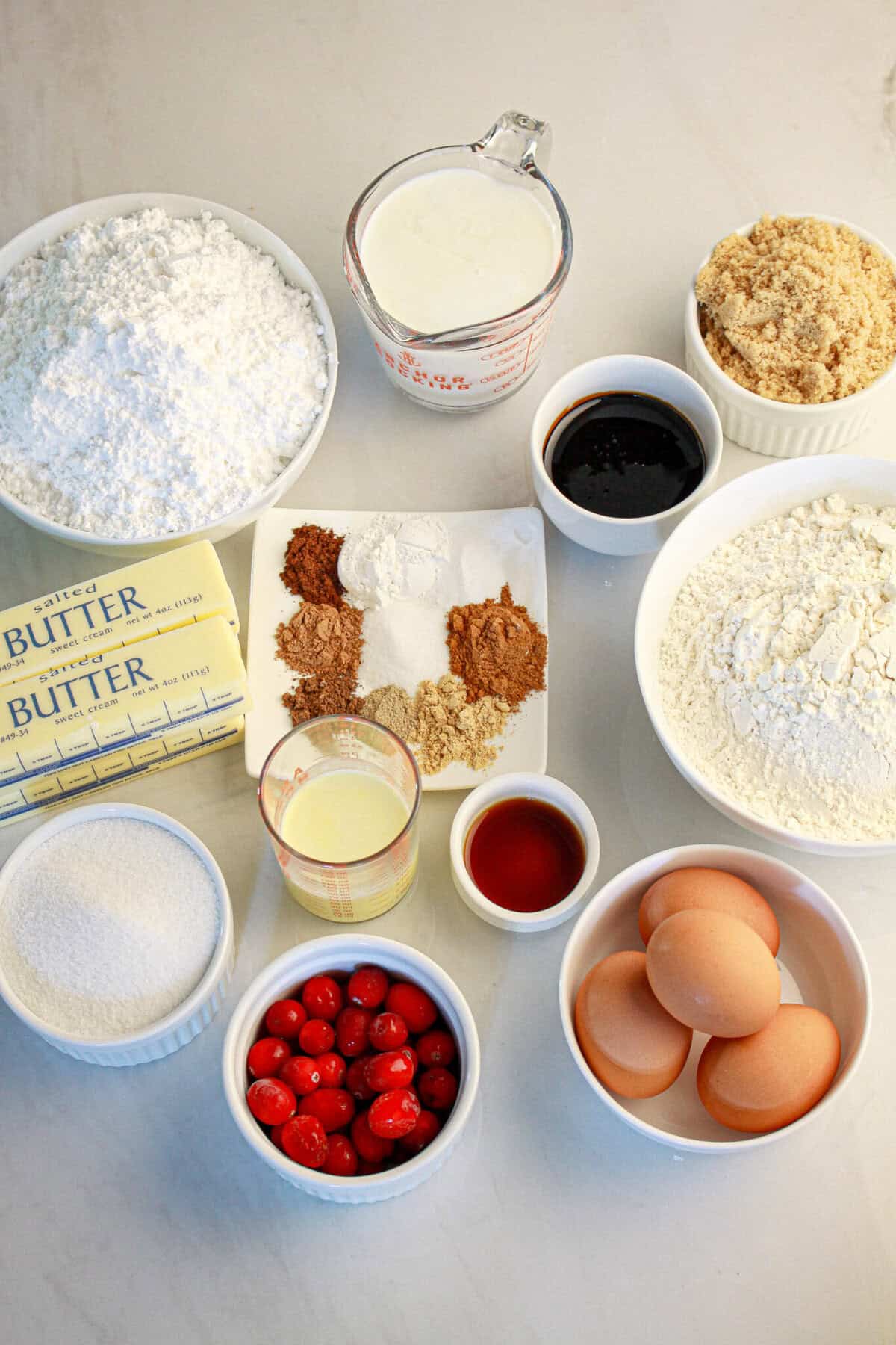 A list of the ingredients all‑purpose flour
baking powder
baking soda
cinnamon
nutmeg
allspice
cardamom
ground ginger
ground cloves
salt
unsalted butter
granulated white sugar
packed dark brown sugar
large eggs
molasses
vanilla extract
buttermilk
powdered sugar
eggnog
sugared cranberries (optional)