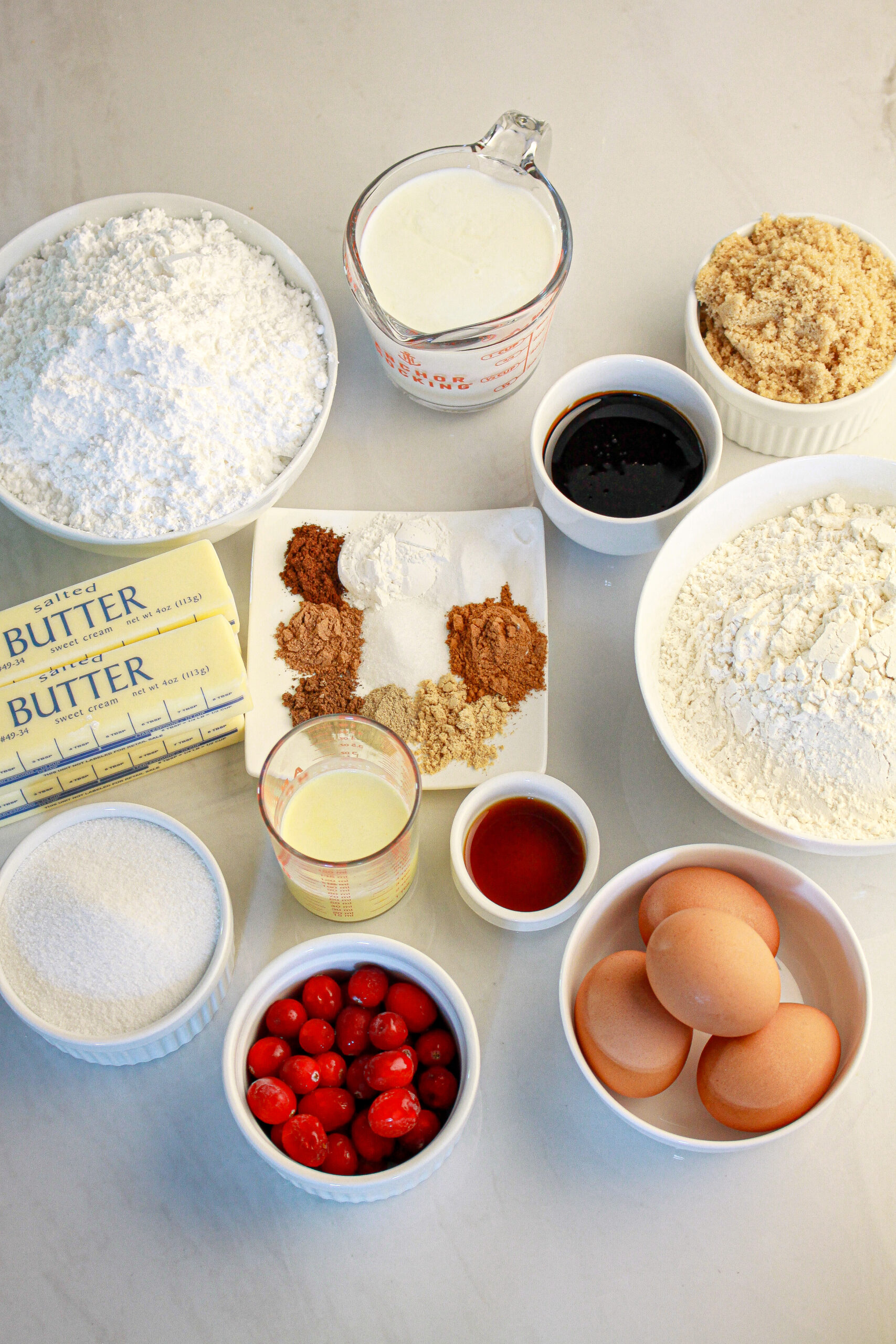 A list of the ingredients all‑purpose flour

baking powder

baking soda

cinnamon

nutmeg

allspice

cardamom

ground ginger

ground cloves

salt

unsalted butter

granulated white sugar

packed dark brown sugar

large eggs

molasses

vanilla extract

buttermilk

powdered sugar

eggnog

sugared cranberries (optional)