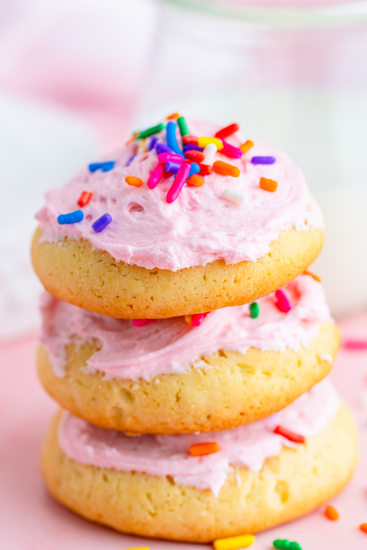 A picture of 3 cookies beautifully decorated with sprinkles 