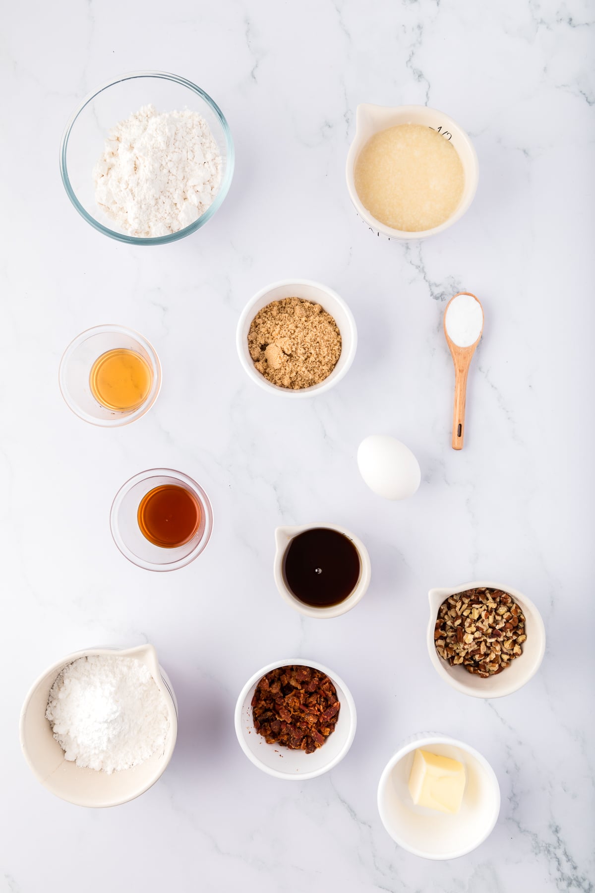 A visual list of the ingredients
all-purpose flour

baking soda

bacon grease

packed dark brown sugar

large egg

pure maple syrup

pure vanilla extract

maple extract

unsalted butter

pure maple syrup

confectioners’ sugar

chopped pecans or walnuts