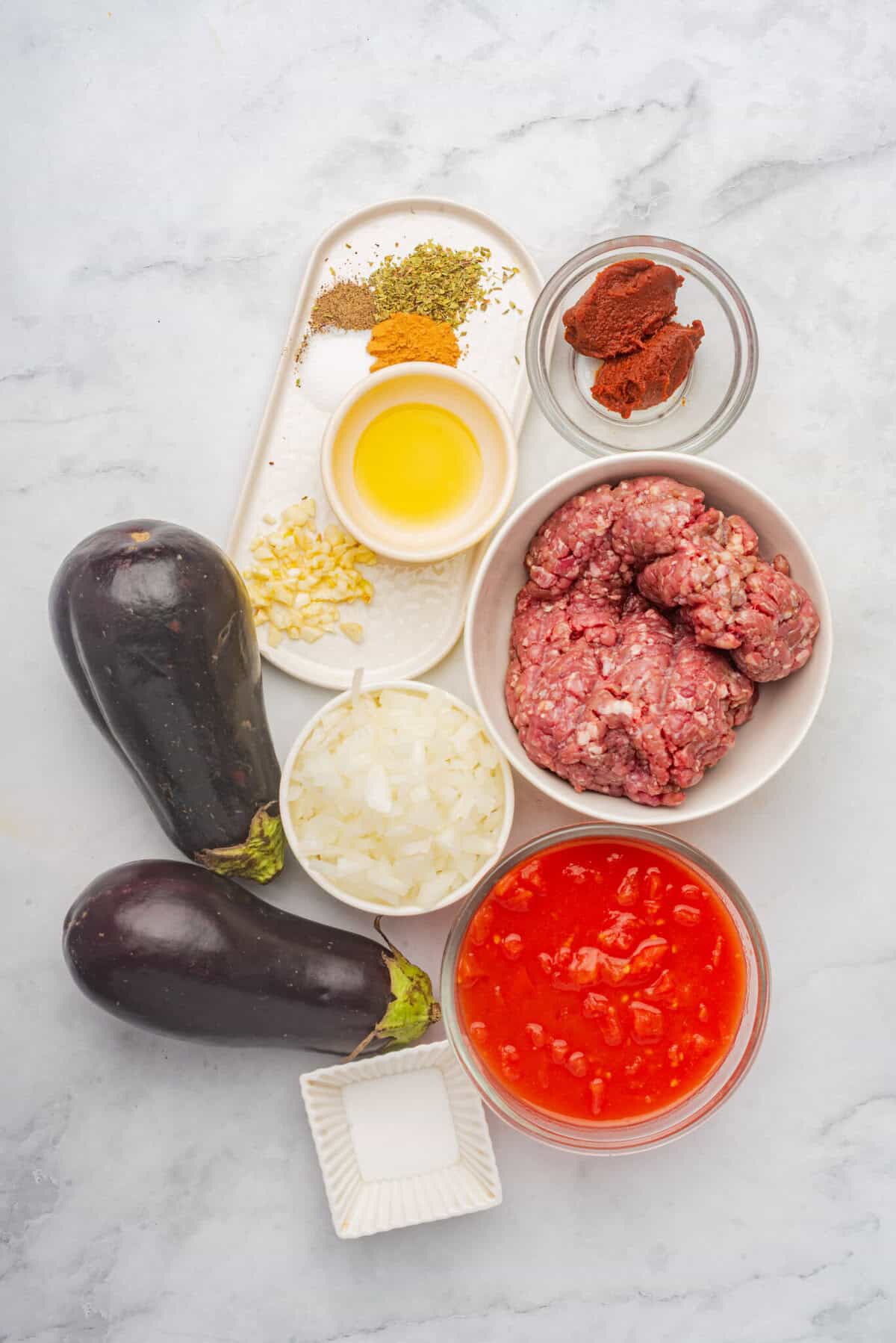 Close your eyes and picture a cozy kitchen on a hillside in Greece.
You can smell roasted eggplant slices, warm cinnamon, and a bubbly, creamy béchamel sauce turning golden under the oven light.
That, my friend, is Moussaka.