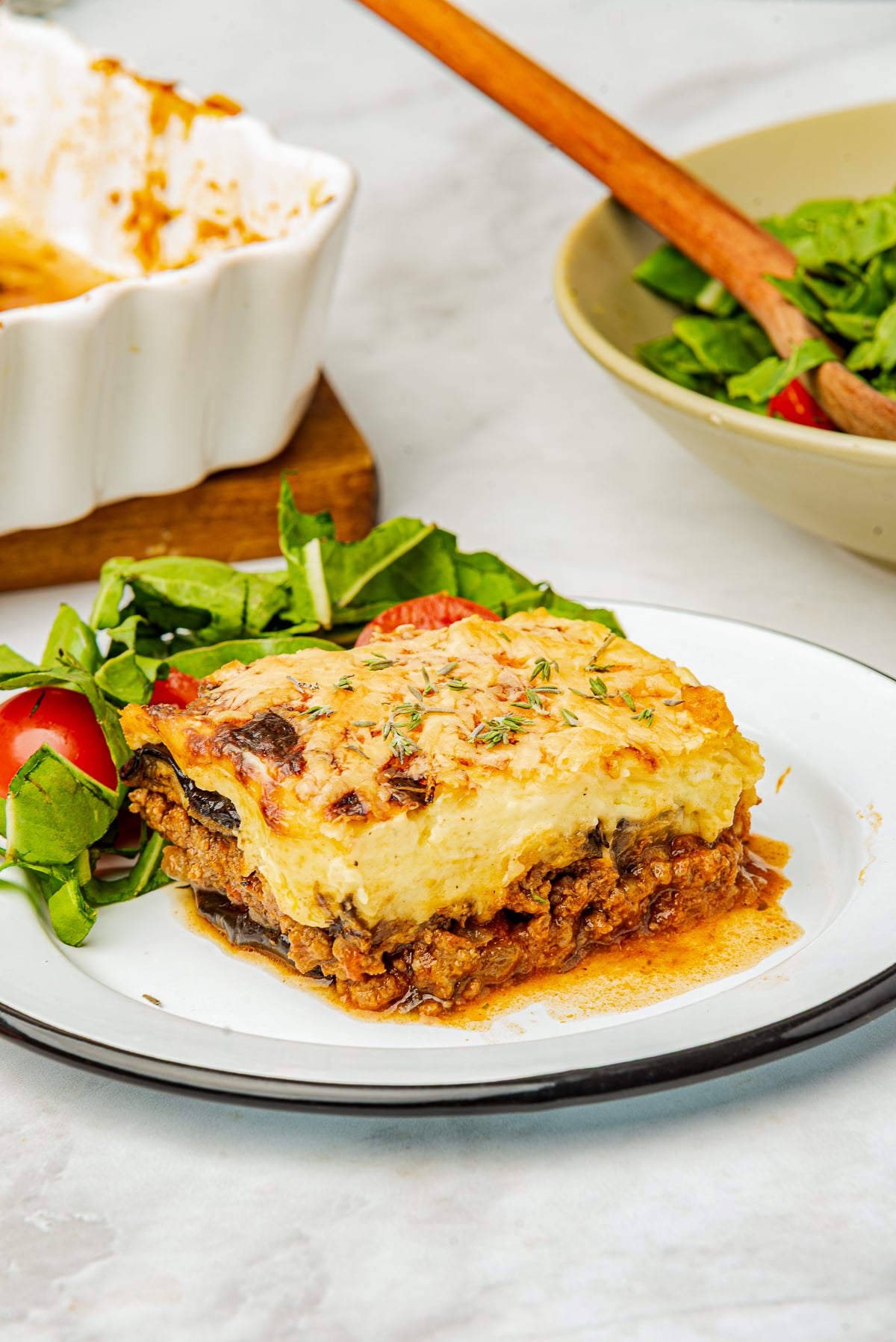 Close your eyes and picture a cozy kitchen on a hillside in Greece.

You can smell roasted eggplant slices, warm cinnamon, and a bubbly, creamy béchamel sauce turning golden under the oven light.

That, my friend, is Moussaka.