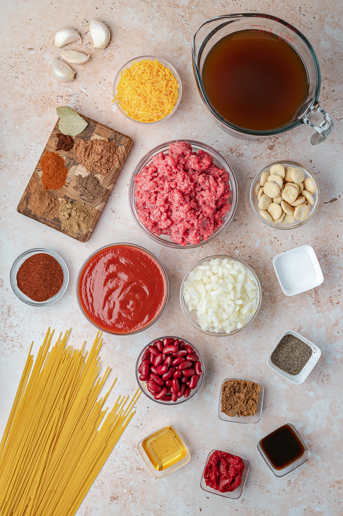 This is a picture of these ingredients
ground beef

yellow onion

garlic

tomato paste

chili powder

unsweetened cocoa powder

ground cinnamon

ground cumin

allspice

ground cloves

Worcestershire sauce

brown sugar

apple cider vinegar

cayenne pepper

salt

black pepper

bay leaves

tomato sauce

beef broth

spaghetti

cheddar cheese

sweet onion

red kidney beans

oyster crackers