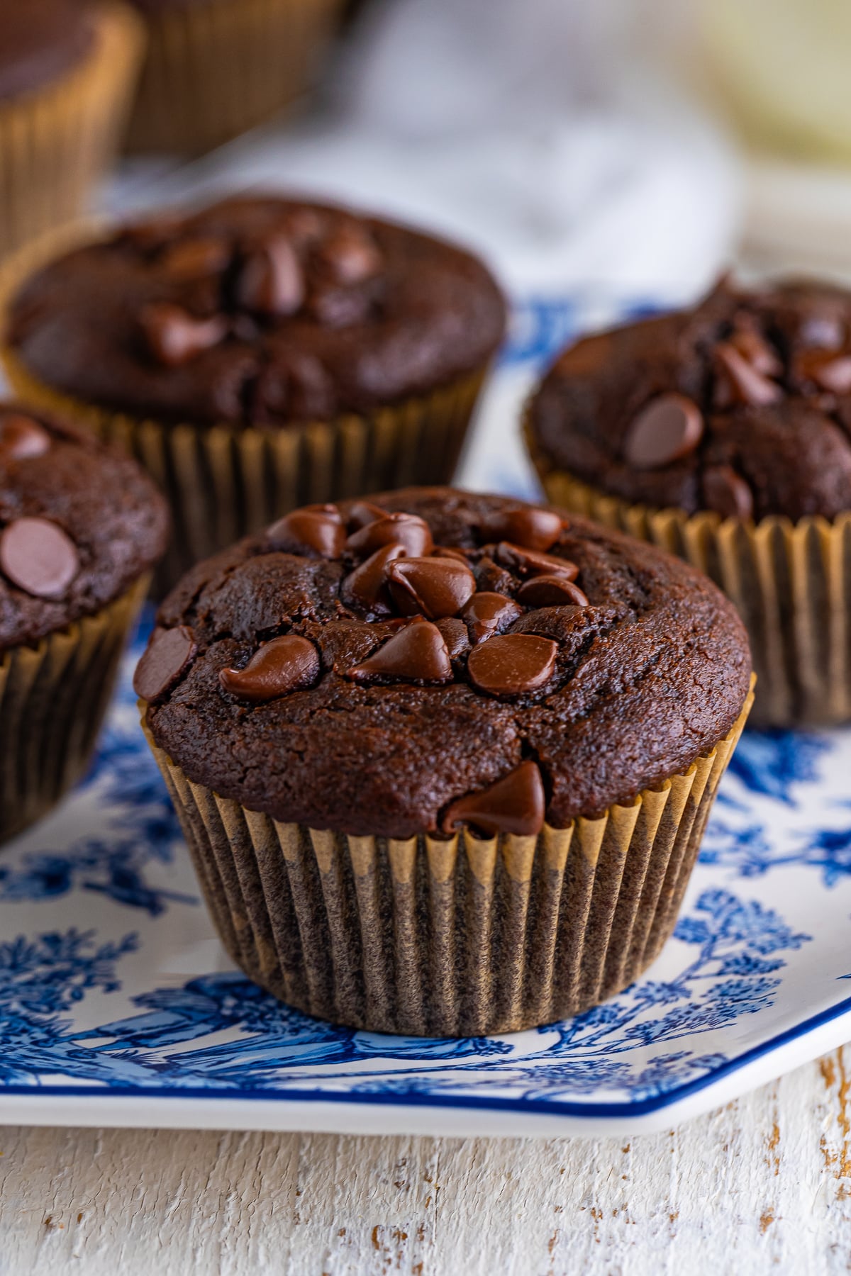 Who doesn’t get excited when the kitchen smells like warm, gooey chocolate?

 These Chocolate Muffins are the kind you see in a coffee shop bakery case—soft, fluffy muffins filled with melty dark chocolate chips and topped with extra chocolate chunks for good measure.

You can whip up a whole batch of chocolate muffins at home with simple ingredients you probably already have in your pantry!