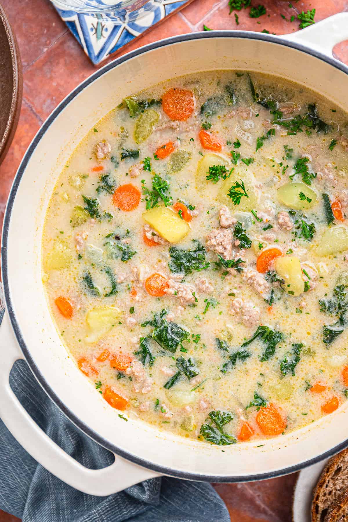 A pot of creamy Zuppa Toscana soup with sausage, potatoes, and kale.