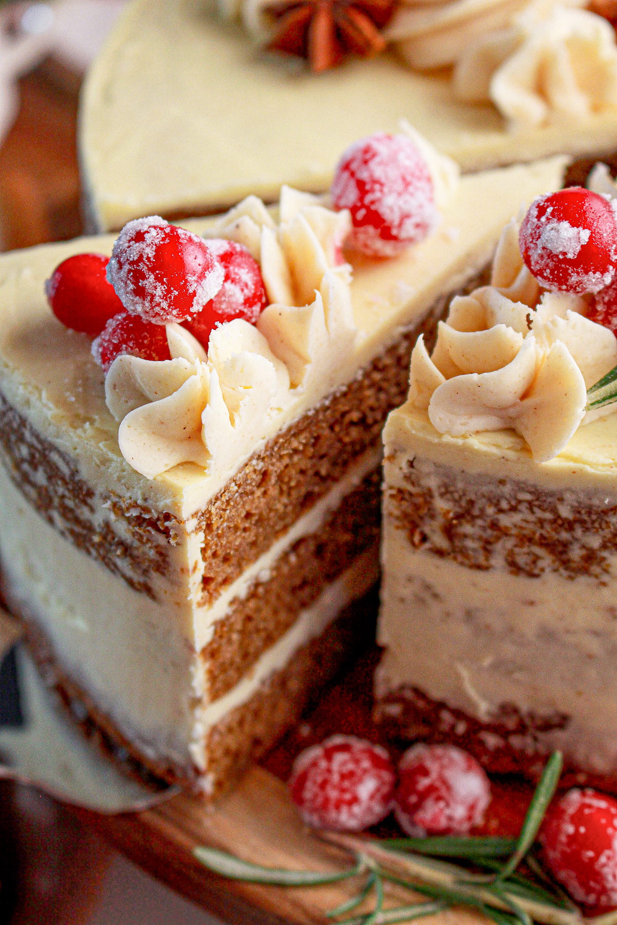 A picture of two slices of cake.  One is pulled sligtly out to show the sponge and layers of frosting.