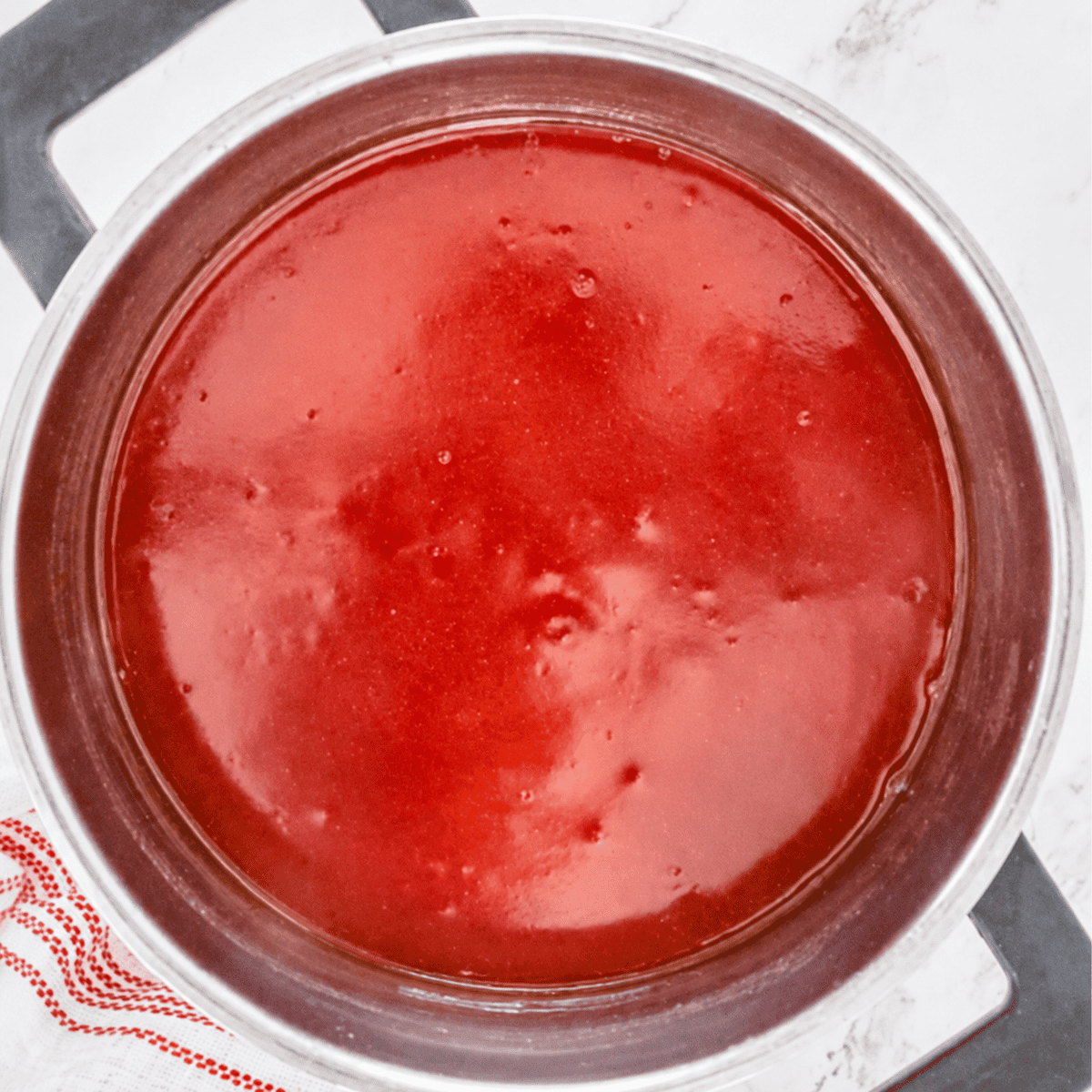 Glossy thickened Sweet and Sour Sauce finished in the saucepan ready to serve.