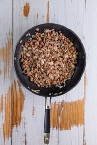 Browning ground beef and diced sweet onion in a large skillet for Maid Rite Recipe.