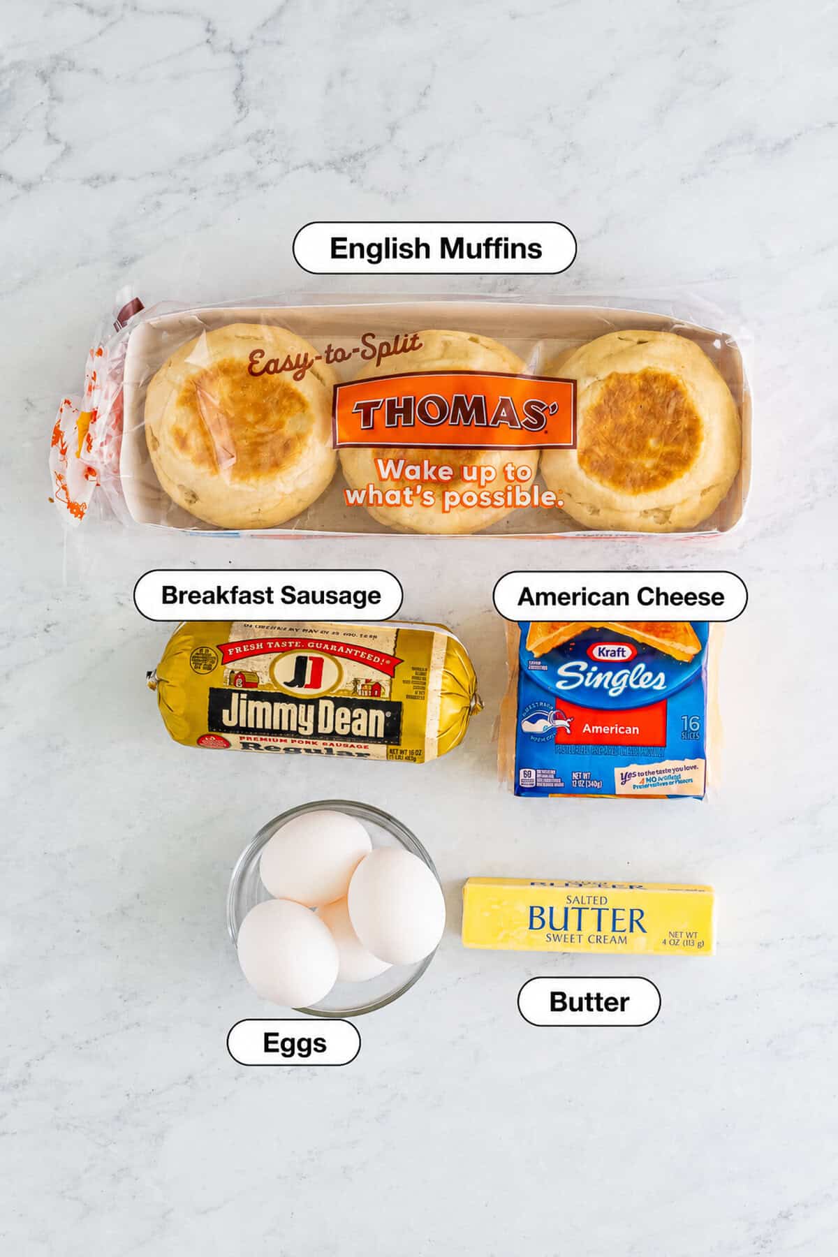 Labeled ingredients for the Sausage Egg McMuffin Recipe including Thomas English Muffins, Jimmy Dean breakfast sausage, Kraft American cheese, eggs, and salted butter.
