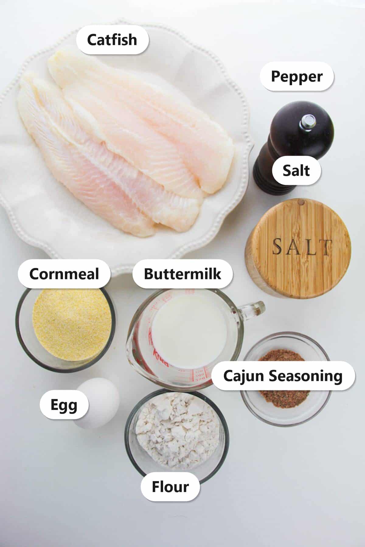 Air Fryer Catfish Nuggets ingredients labeled including catfish, cornmeal, buttermilk, flour, egg, cajun seasoning, salt, and pepper.