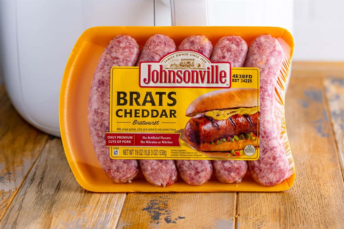A package of Johnsonville Cheddar Brats sausages on a kitchen counter ready for the Johnsonville Brats in Air Fryer recipe.