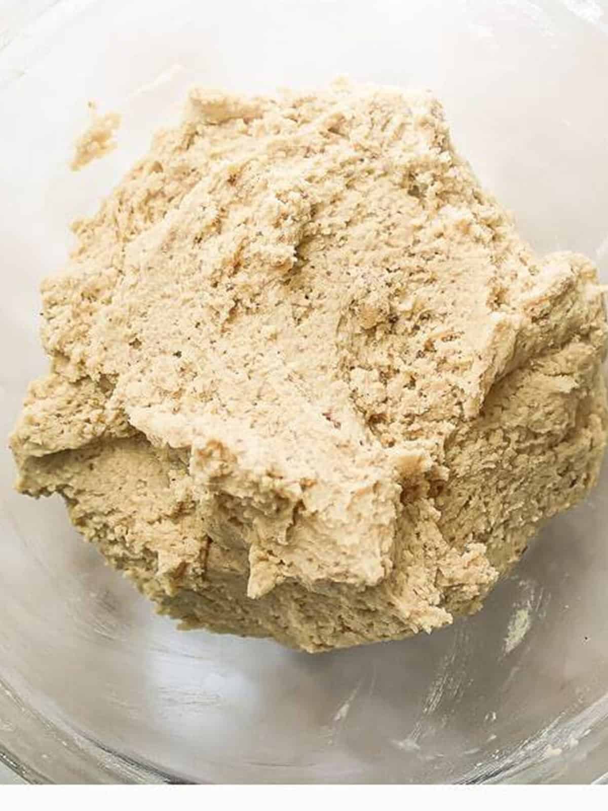 Almond cookie dough creamed together until smooth in a mixing bowl.
