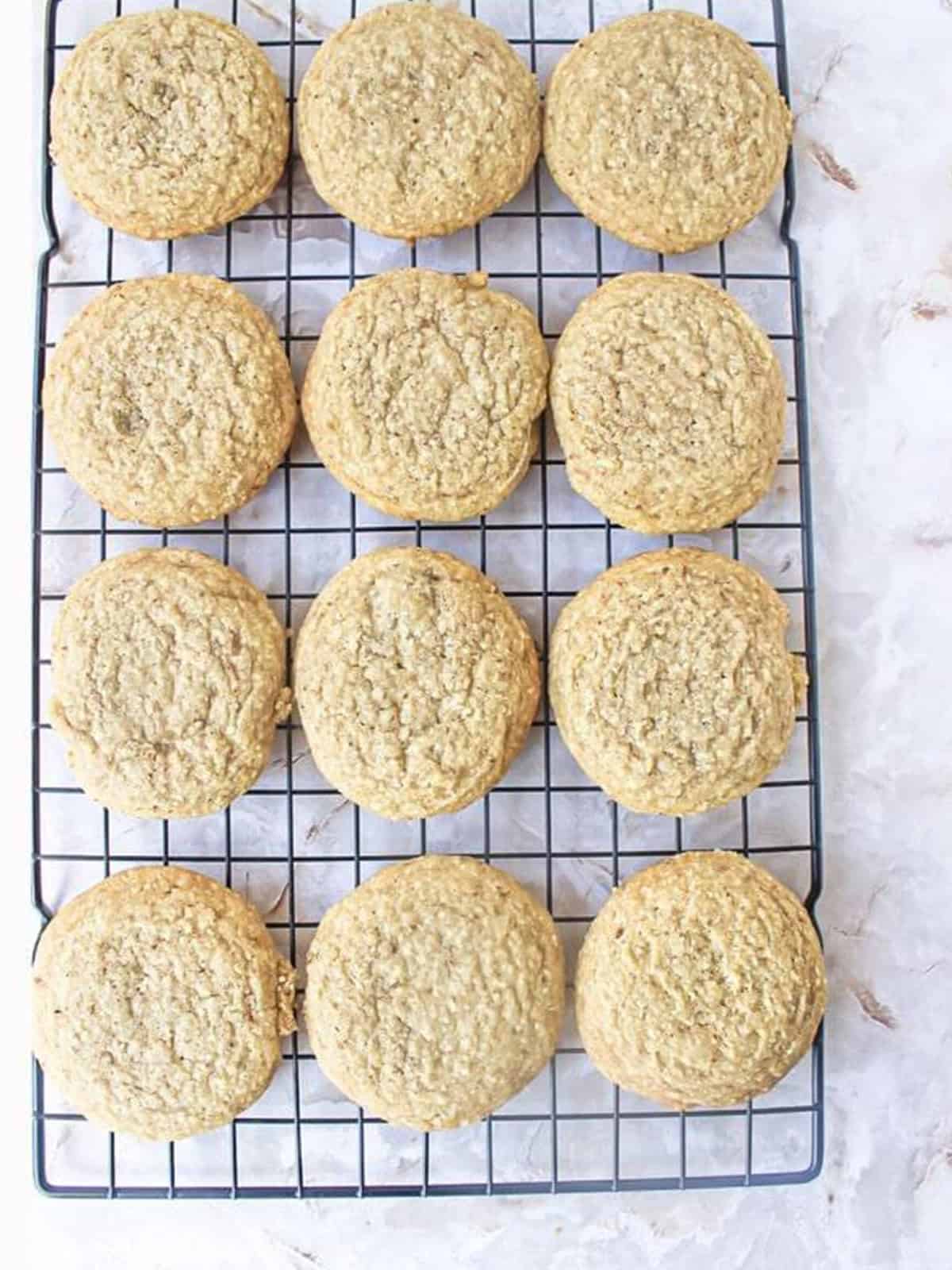 Baked golden almond cookies cooling on a wire rack.