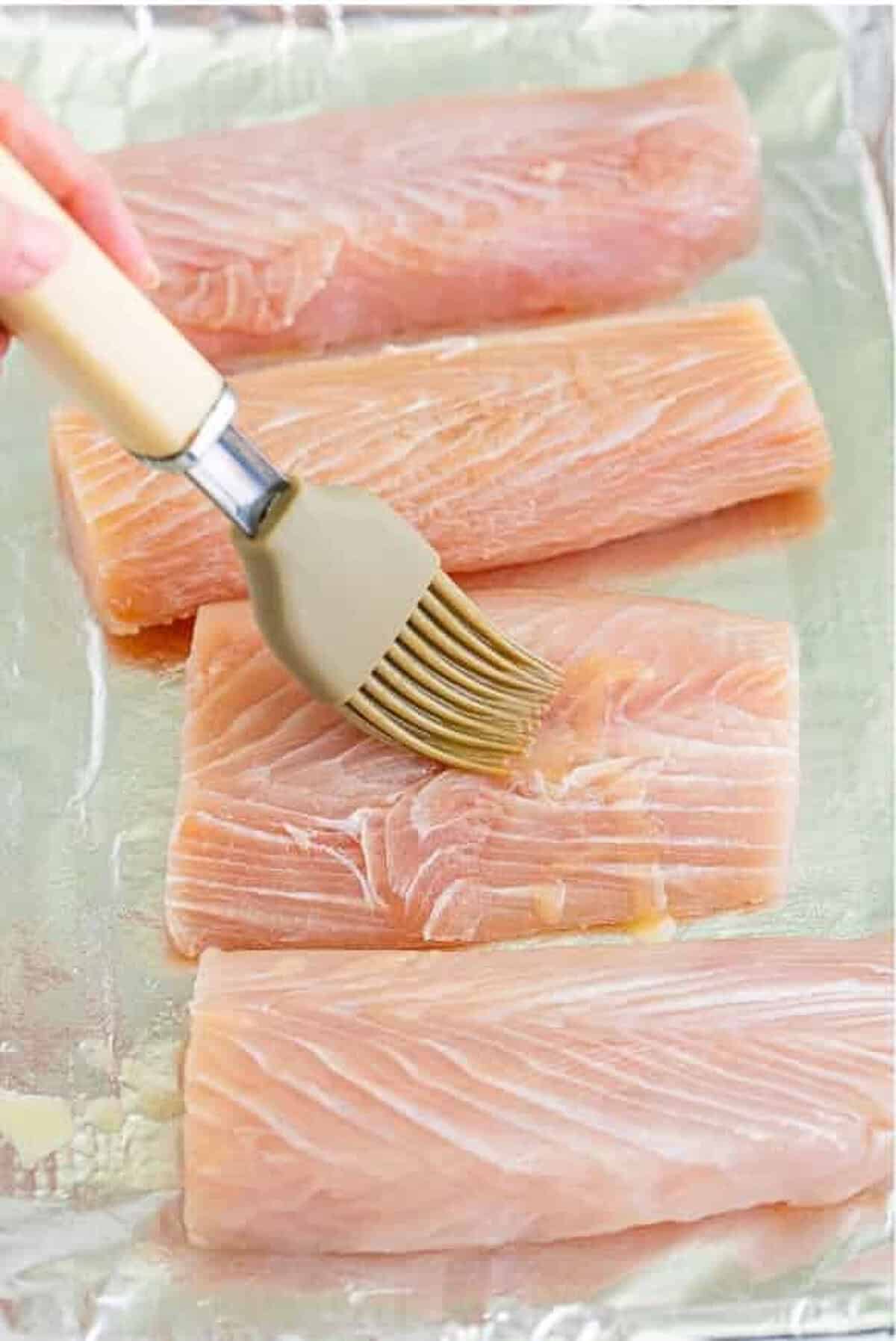 Patting Mahi Mahi Recipe fillets dry and placing them on a prepared sheet tray.