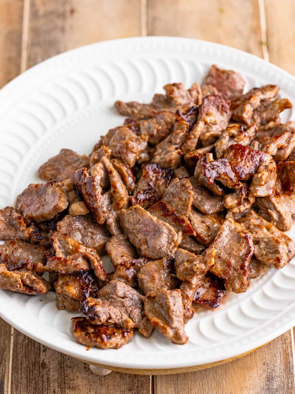 Seared beef tips resting on a plate.