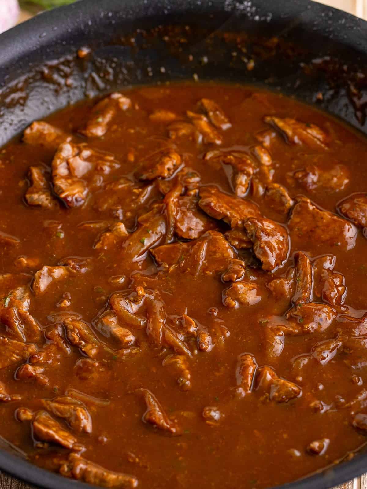 Beef tips simmering in the thickened onion gravy.