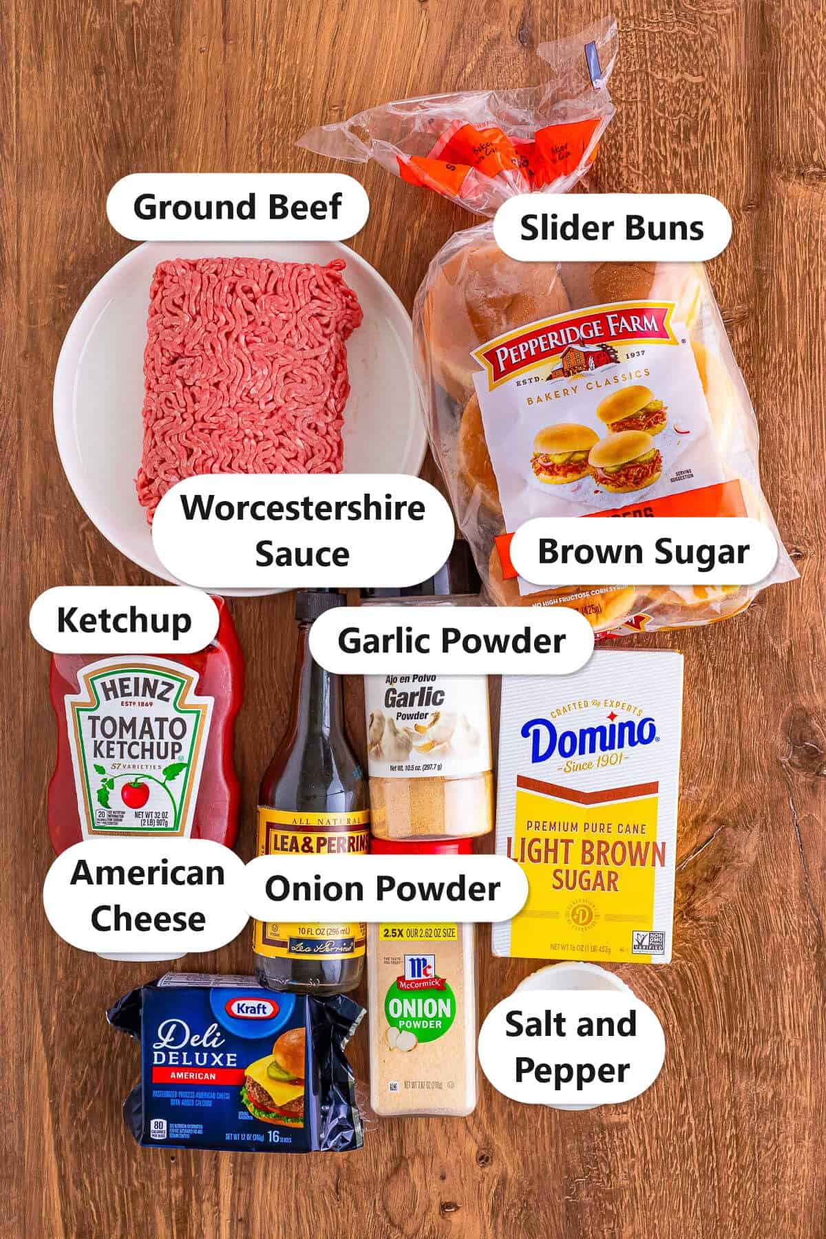Labeled ingredients to make cheeseburger sliders including ground beef, ketchup, Worcestershire sauce, garlic powder, onion powder, brown sugar, American cheese, salt and pepper, and slider buns.