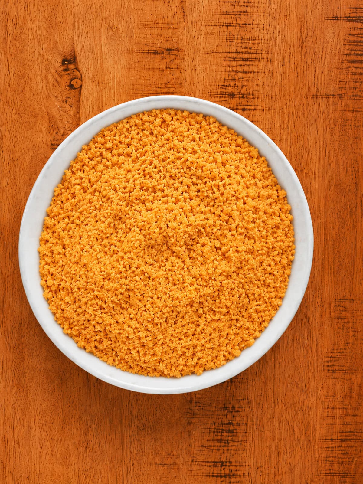 Ground Chedz cheese cracker crumbs mixed with black pepper in a large bowl.