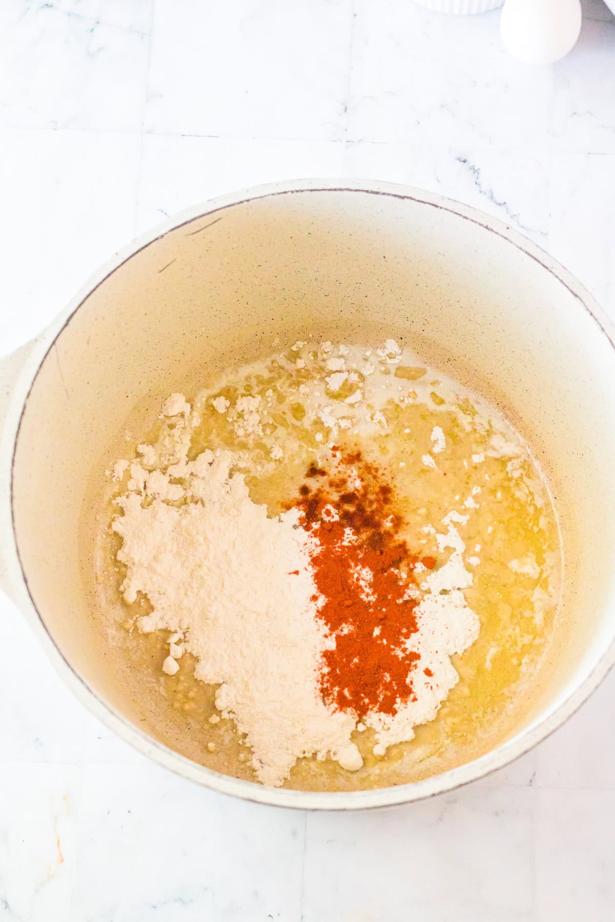 Butter, flour, salt, and paprika in a Dutch oven starting the roux for Chick Fil A Mac and Cheese Recipe.