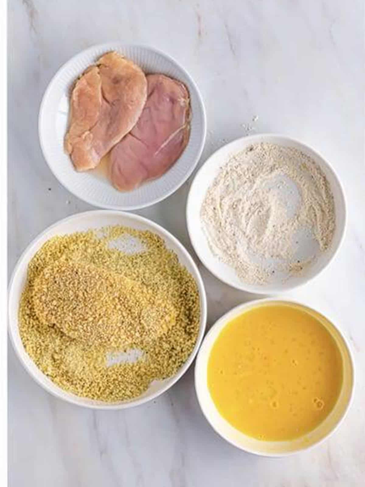 Breaded chicken cutlets coated in seasoned panko for chicken parmesan sandwiches.