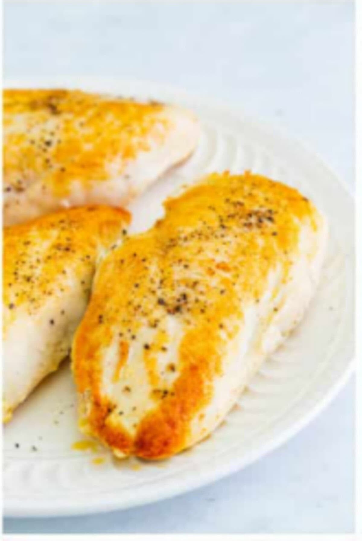Seared chicken breasts golden brown on both sides in a Dutch oven for Copycat Chili Chicken Enchilada Soup.