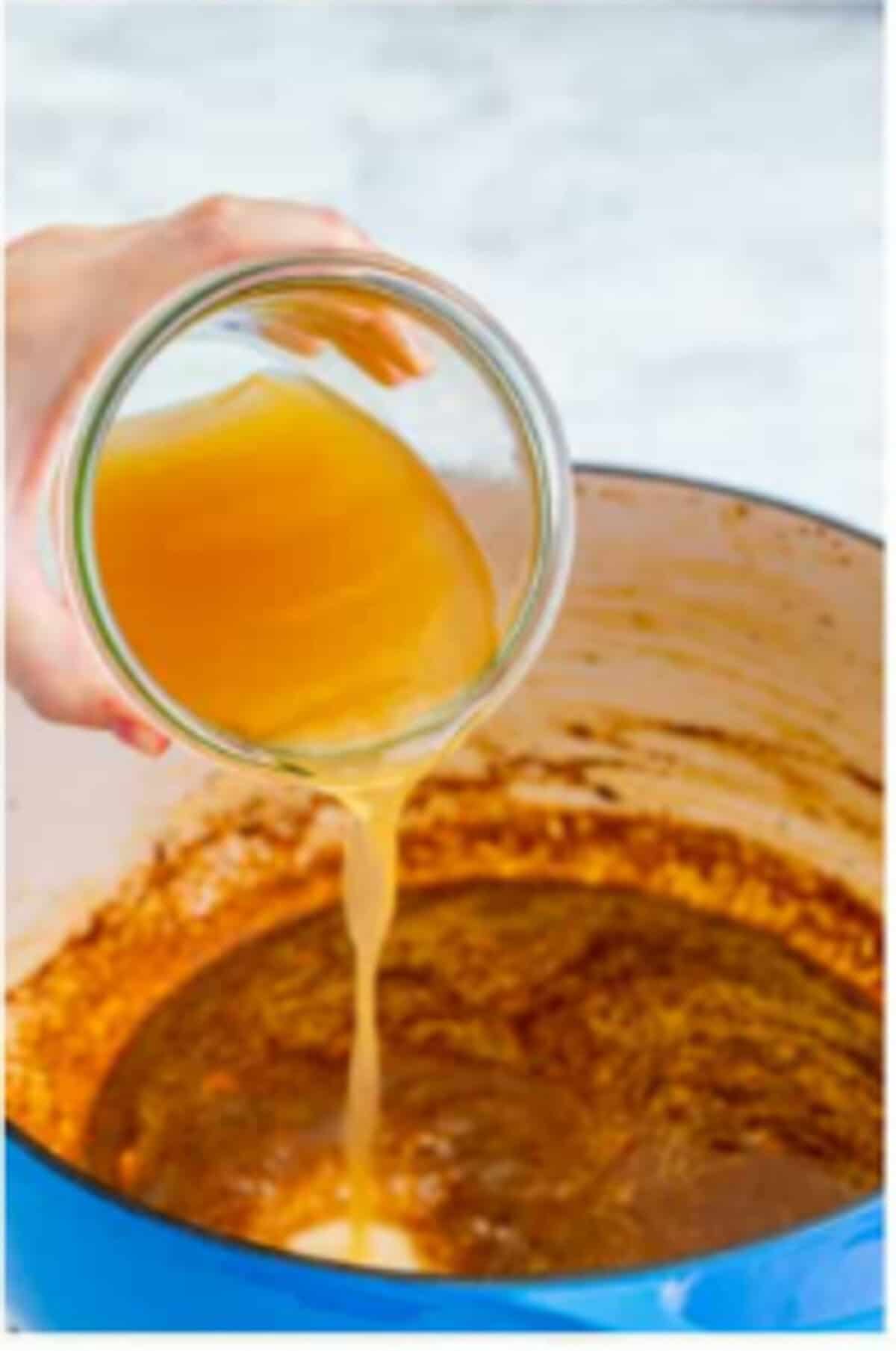 Chicken stock added to the Dutch oven with seared chicken returned to the pot for Copycat Chili Chicken Enchilada Soup.