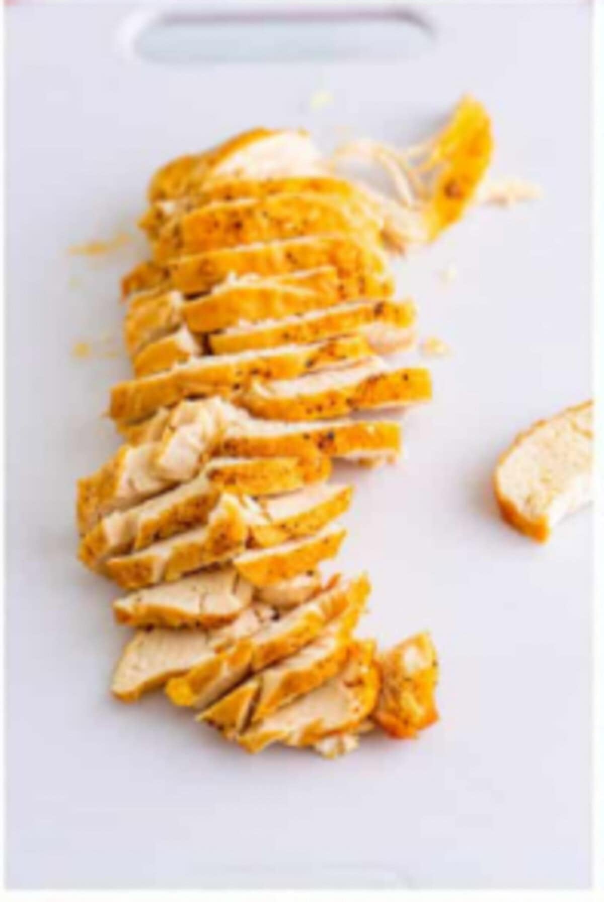 Thinly sliced cooked chicken returned to the pot for Copycat Chili Chicken Enchilada Soup.
