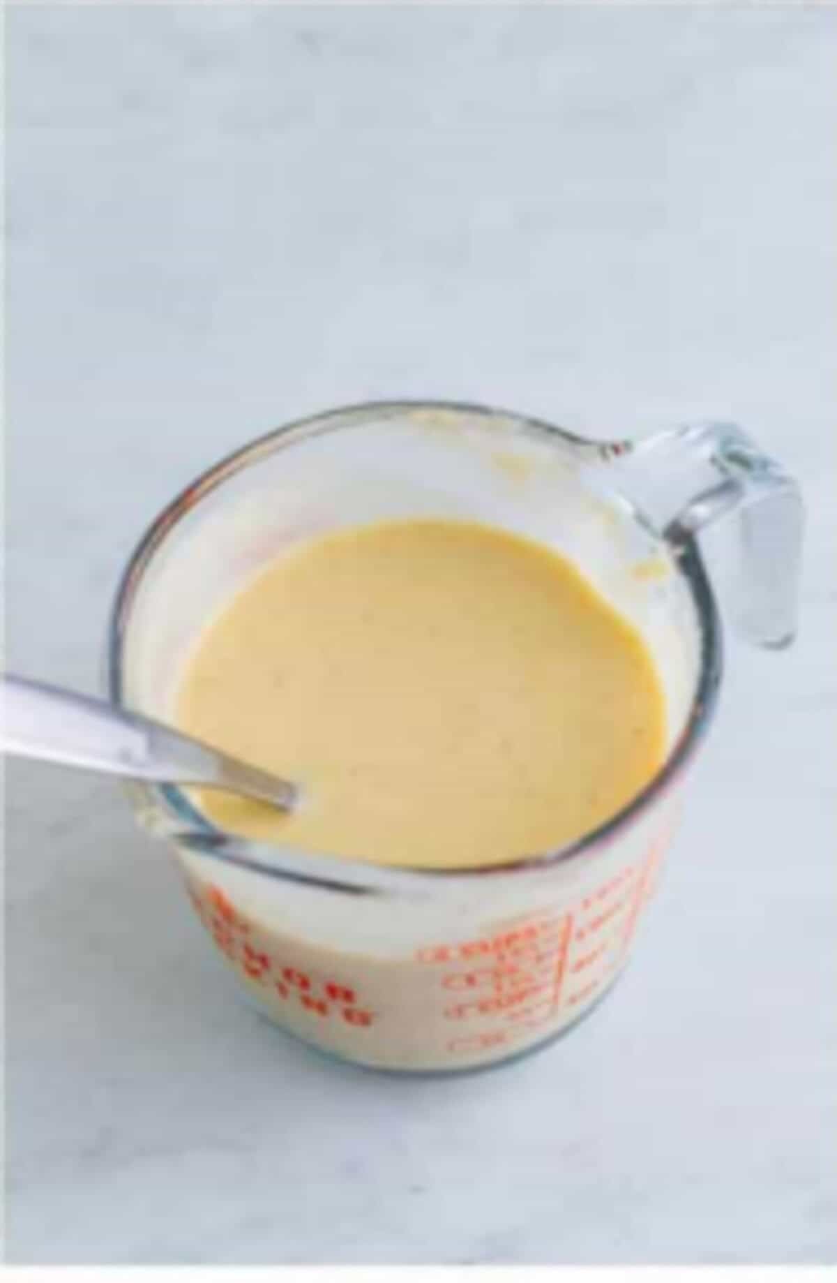 Masa harina whisked with chicken stock being streamed into the simmering pot for Copycat Chili Chicken Enchilada Soup.