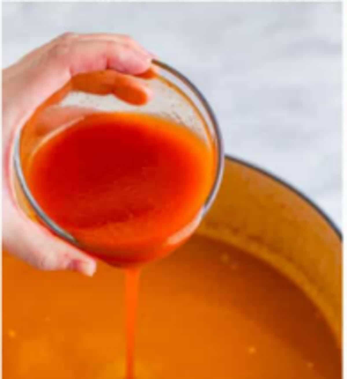 Red enchilada sauce stirred into the soup for Copycat Chili Chicken Enchilada Soup.
