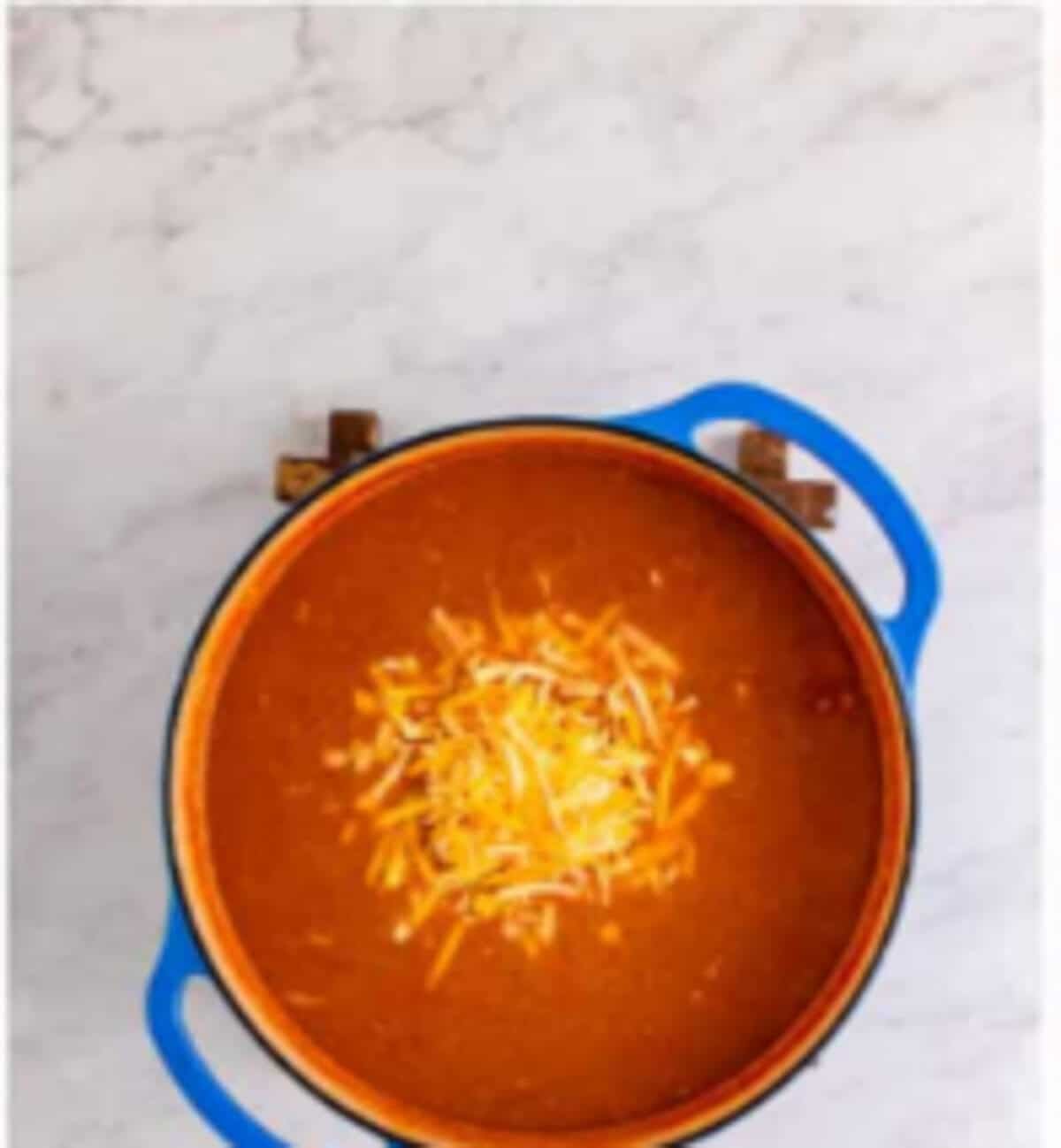 Monterey Jack and sharp cheddar cheese stirred into the finished Copycat Chili Chicken Enchilada Soup.