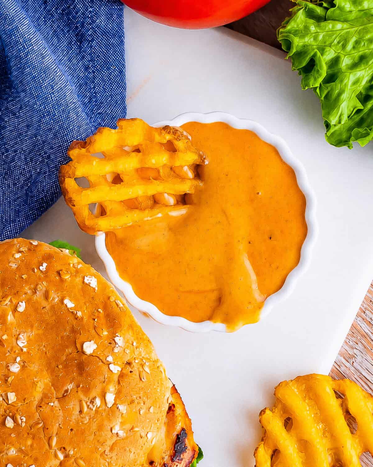 Chick-Fil-A Honey Roasted BBQ Sauce Recipe served alongside crispy chicken tenders, fries, and waffle fries for the full copycat dipping spread.
