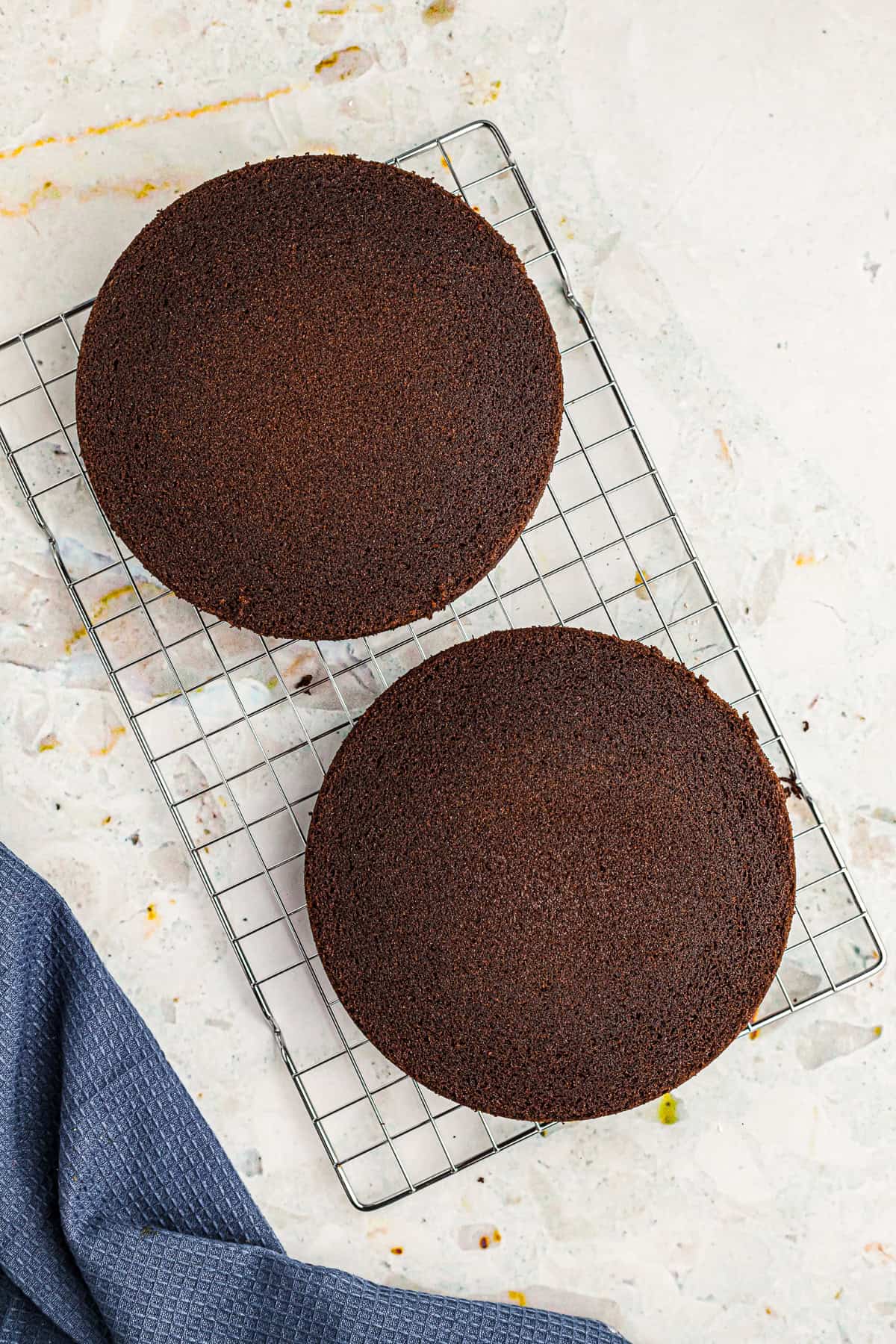 Baked Chocolate Espresso Cake layers cooling on a wire rack before frosting.