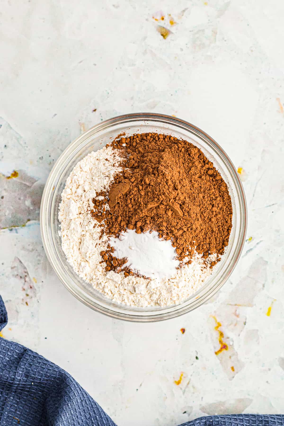 Dry ingredients of flour, cocoa powder, and baking soda whisked together in a bowl for Chocolate Espresso Cake.