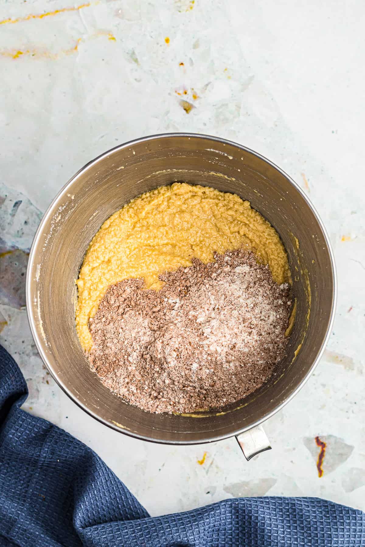 Dry flour and cocoa mixture being folded into the wet Chocolate Espresso Cake batter.