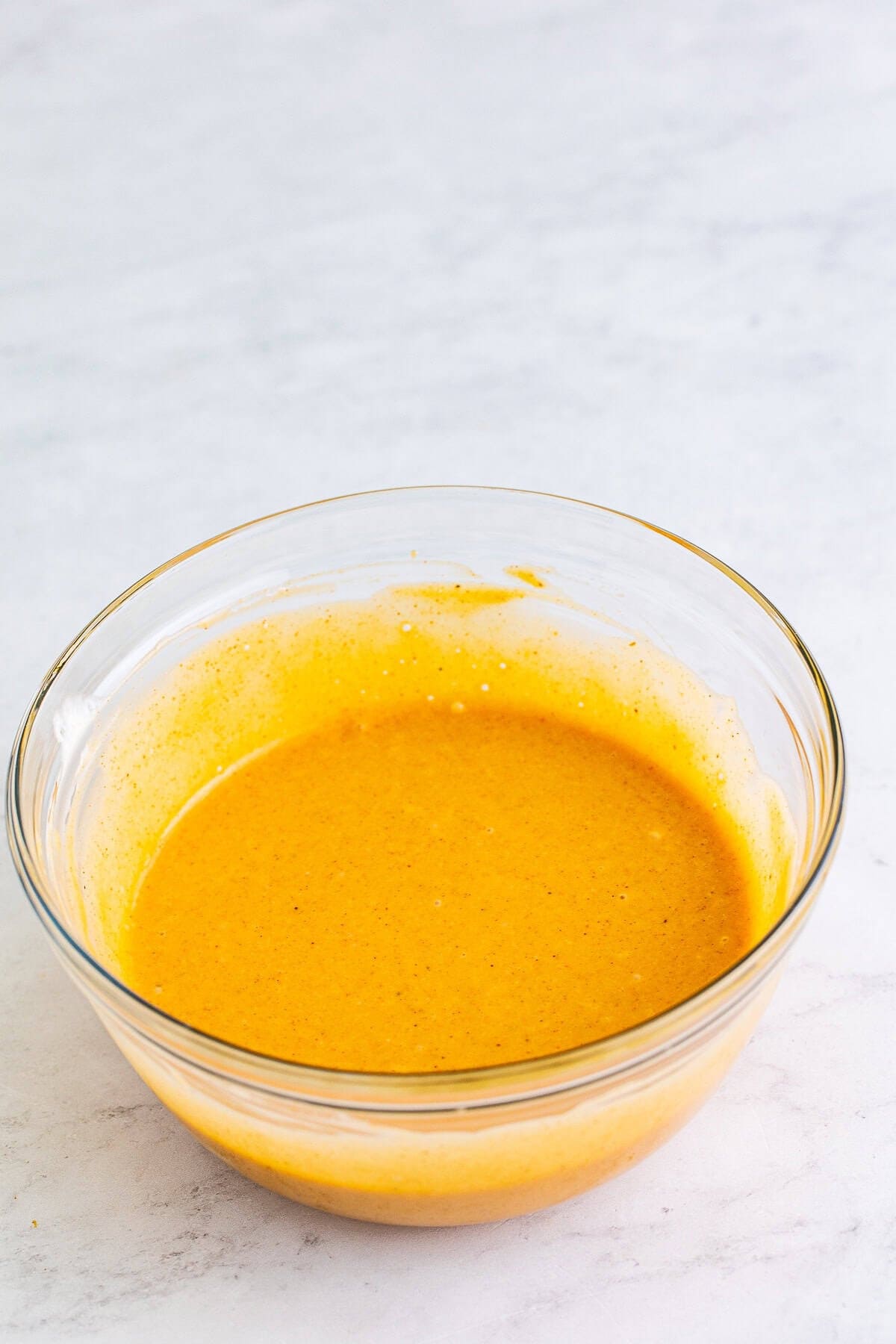 Finished Chick-Fil-A Honey Roasted BBQ Sauce Recipe covered with plastic wrap and chilling in the fridge ready to serve with chicken tenders or fries.