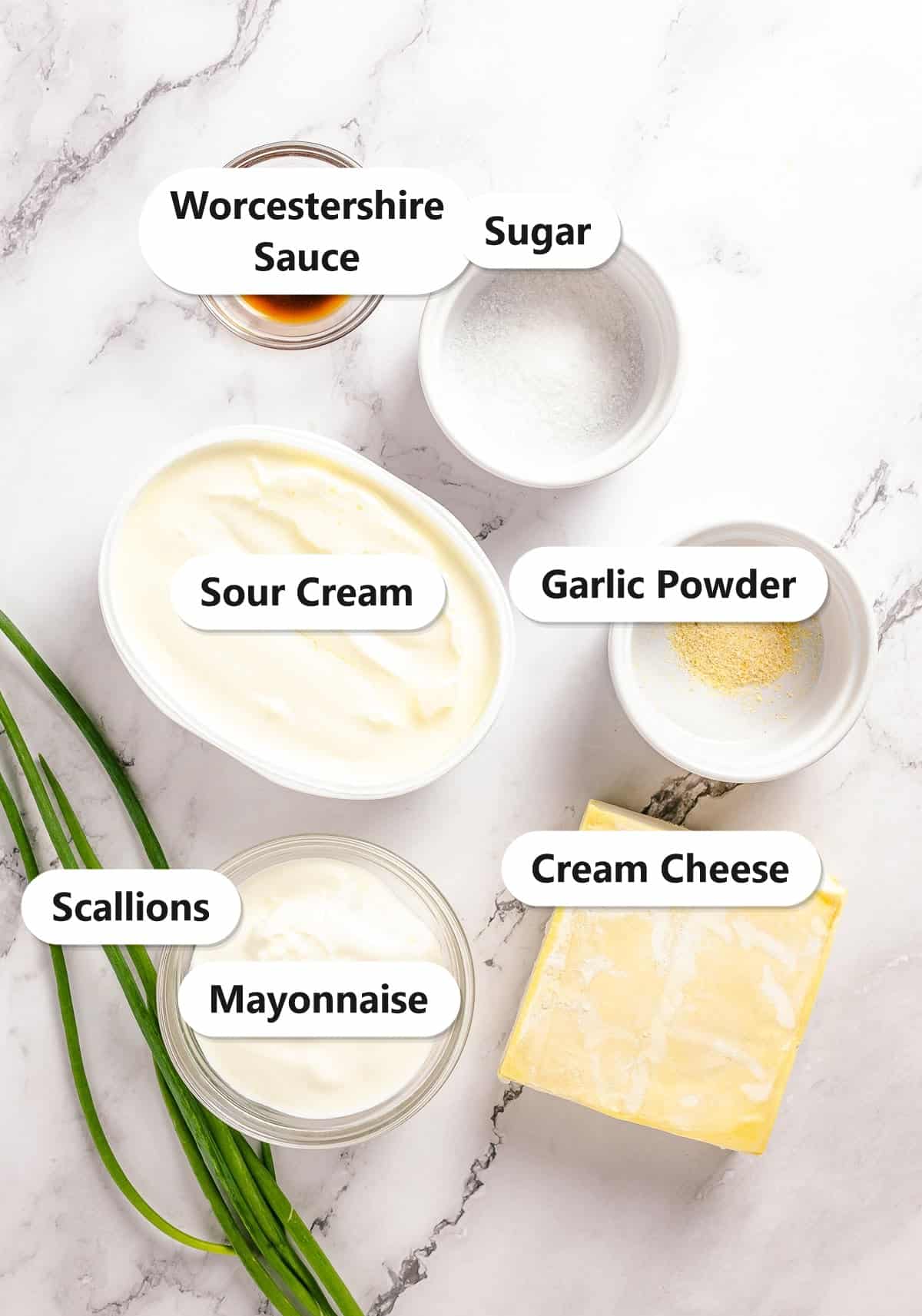 Labeled ingredients to make cream cheese wontons including cream cheese, sour cream, mayonnaise, Worcestershire sauce, garlic powder, sugar, and scallions.