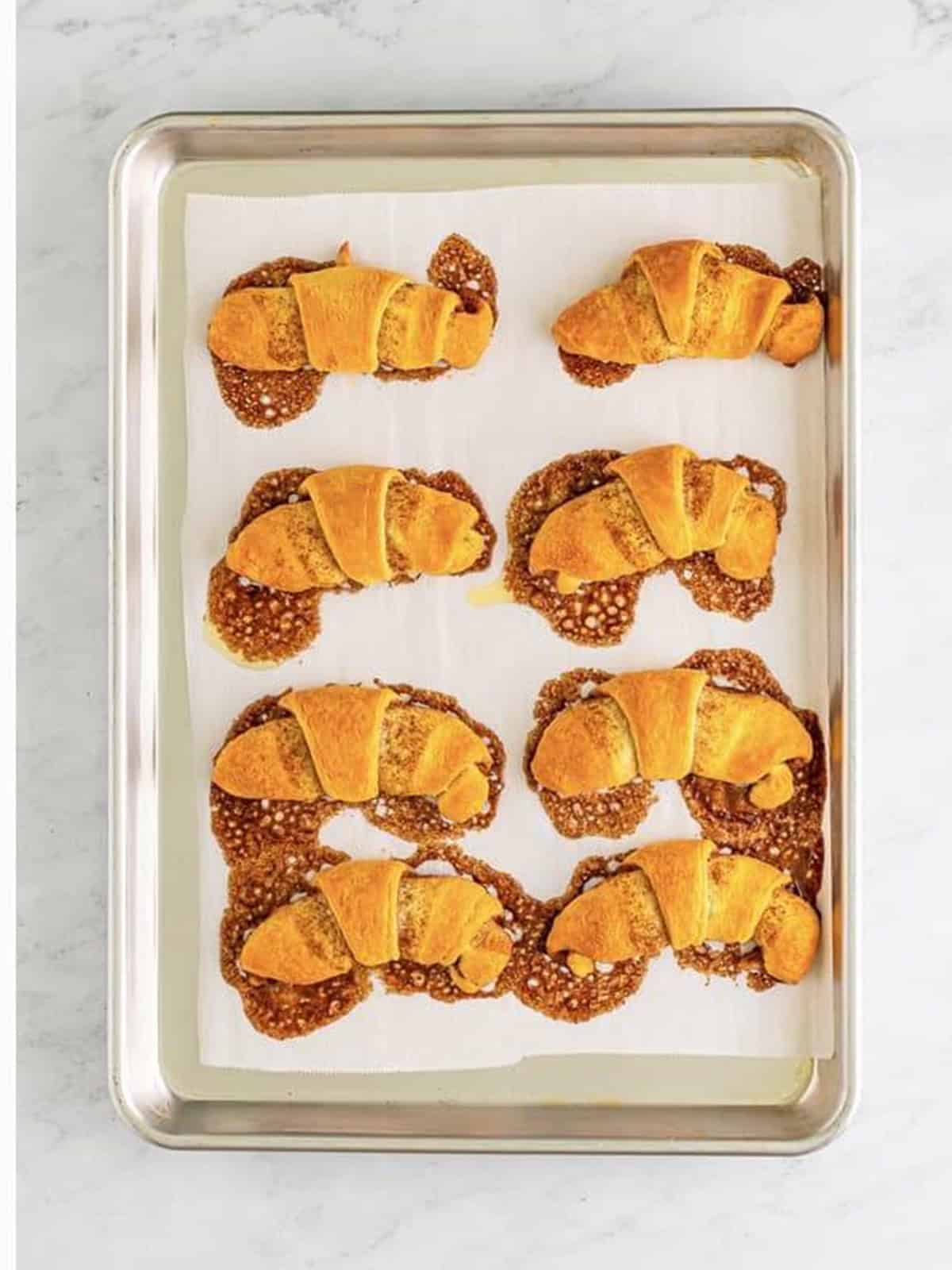 Baked crescent roll cinnamon rolls golden on the pan.
