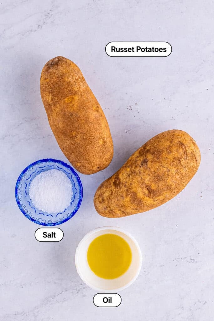 Labeled ingredients for Crispy Baked Potato including russet potatoes, olive oil, kosher salt, and butter for serving.